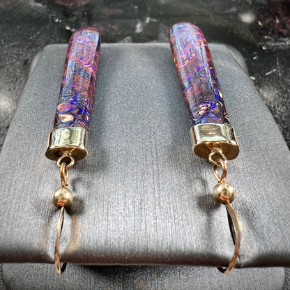 A pair of yellow gold cap Koroit boulder opal dangle earrings.  Purple highlights are seen.