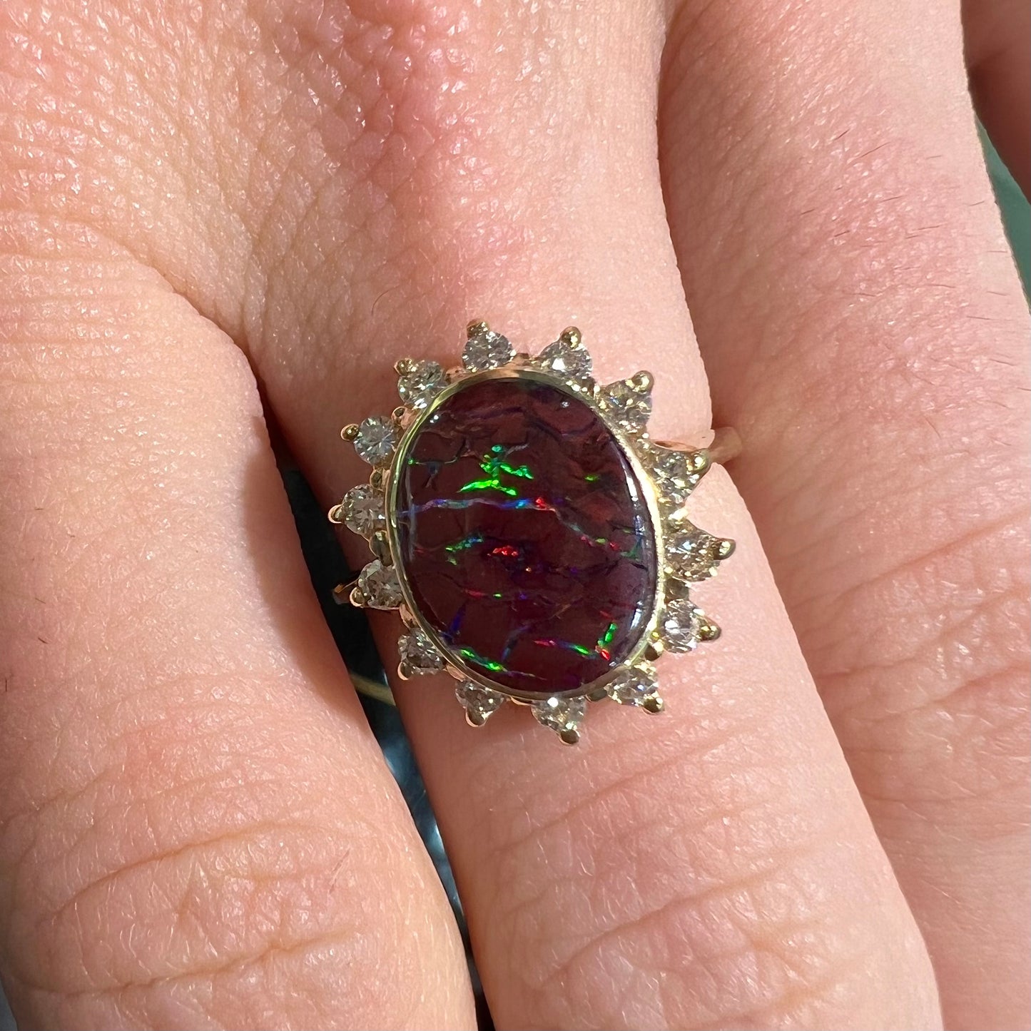 A ladies' diamond halo and Koroit boulder opal engagement ring.