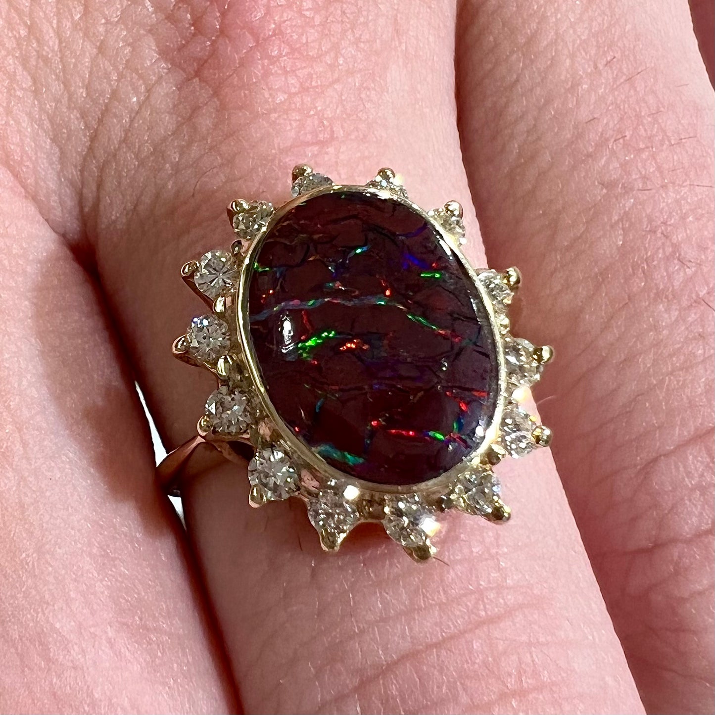 A ladies' diamond halo and Koroit boulder opal engagement ring.