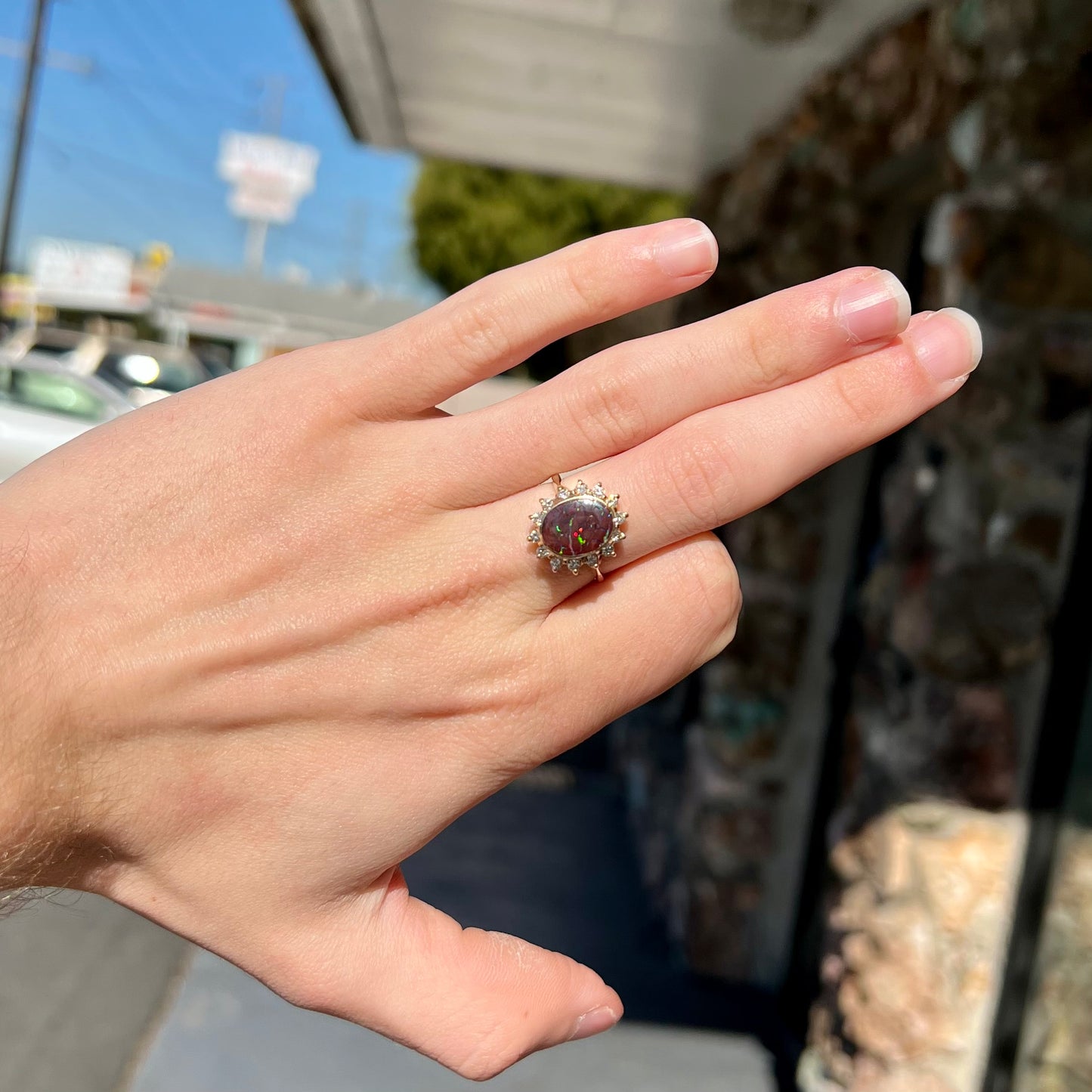 A ladies' diamond halo and Koroit boulder opal engagement ring.