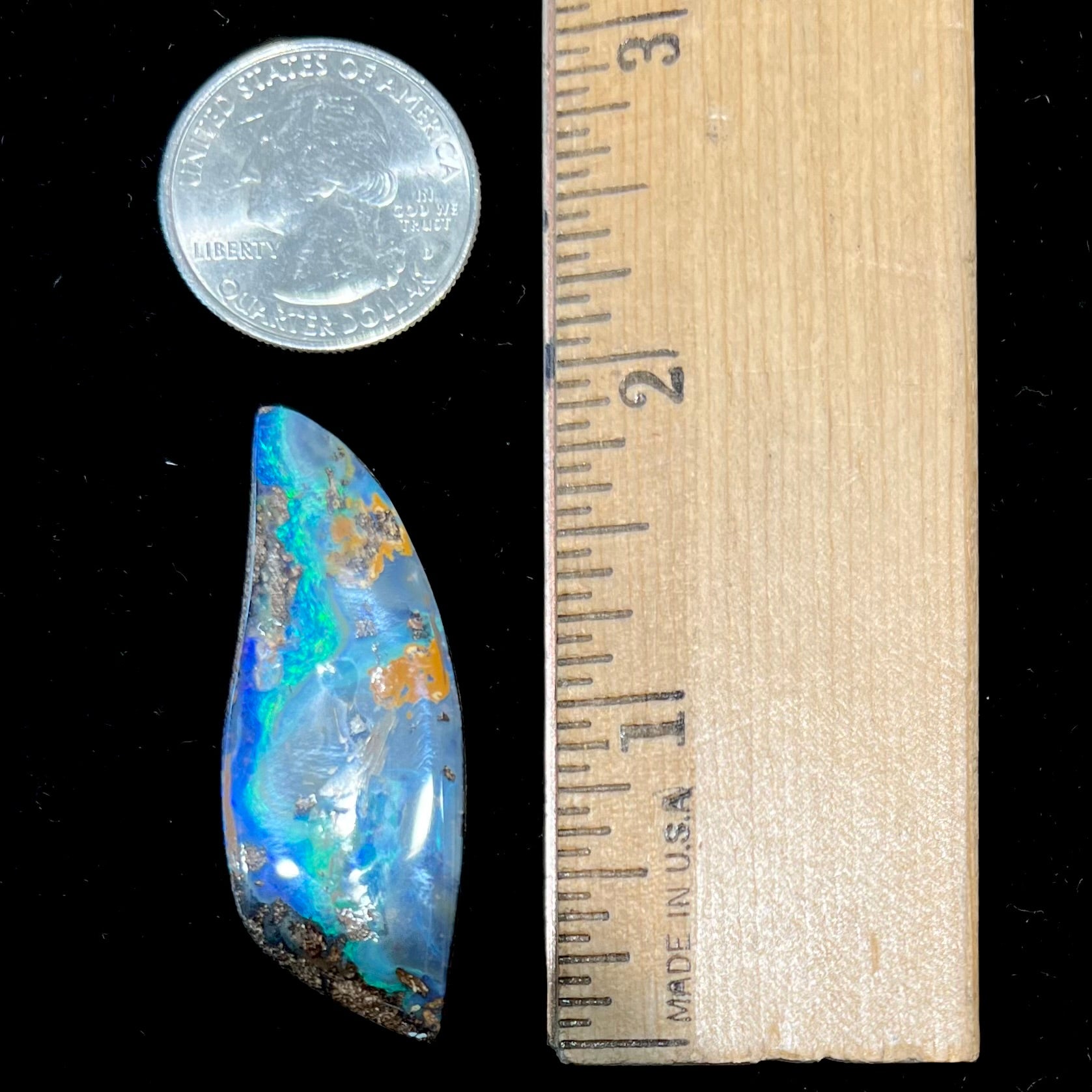A freeform cut, loose black boulder opal stone from Queensland, Australia.