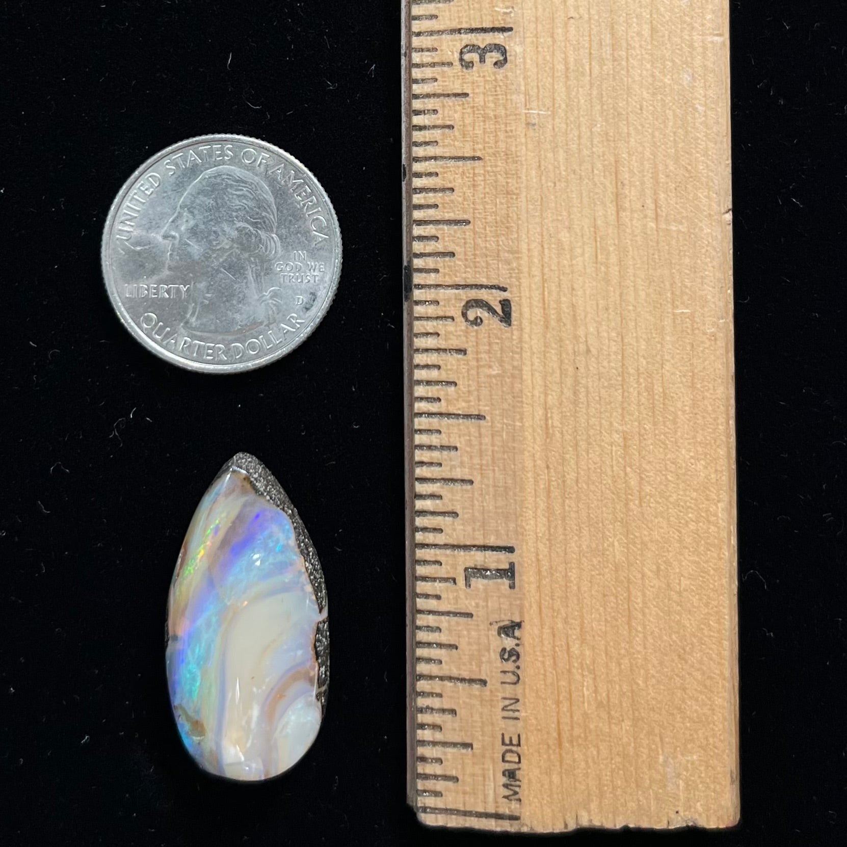 A loose, pear shaped cabochon cut boulder opal stone from Quilpie, Australia.
