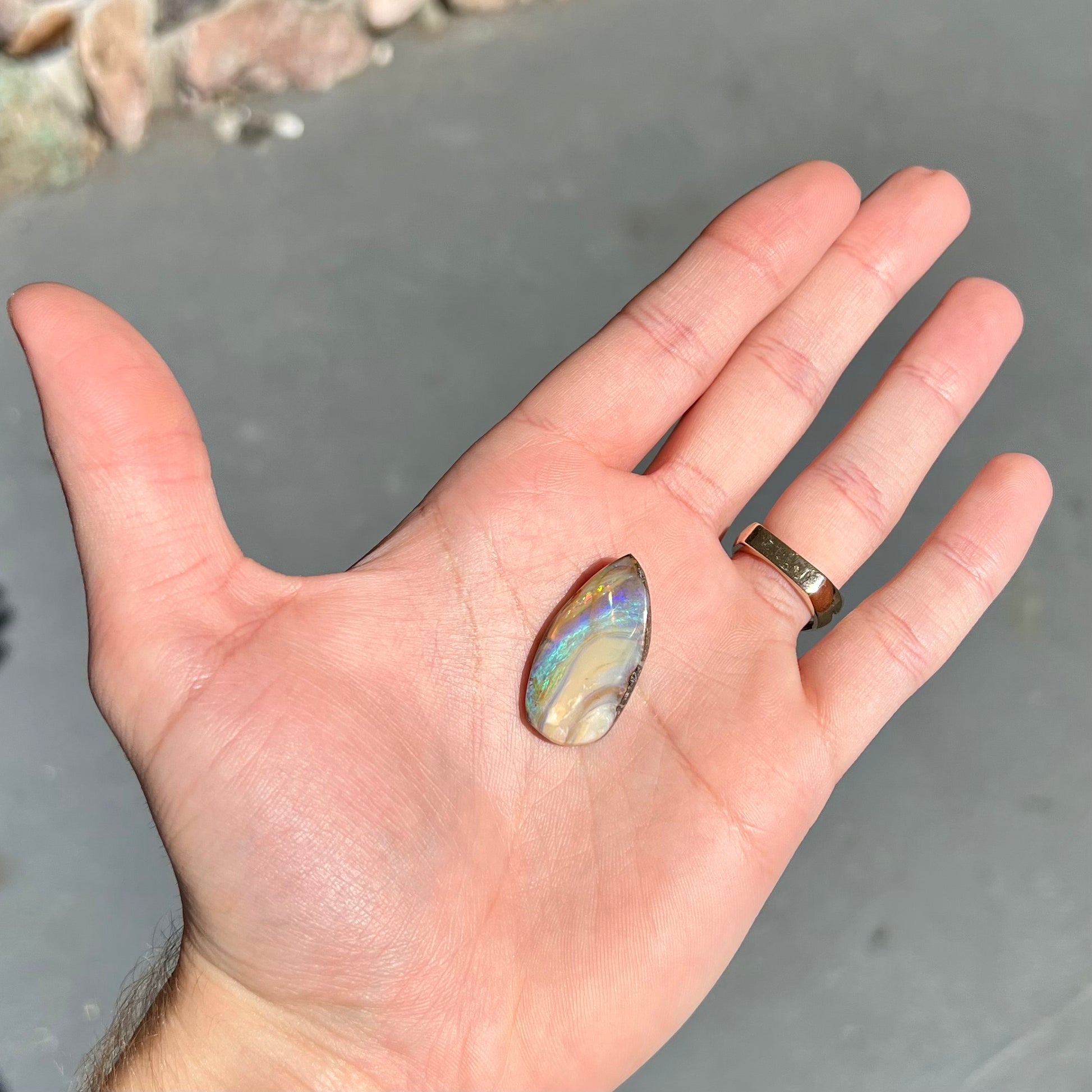 A loose, pear shaped cabochon cut boulder opal stone from Quilpie, Australia.