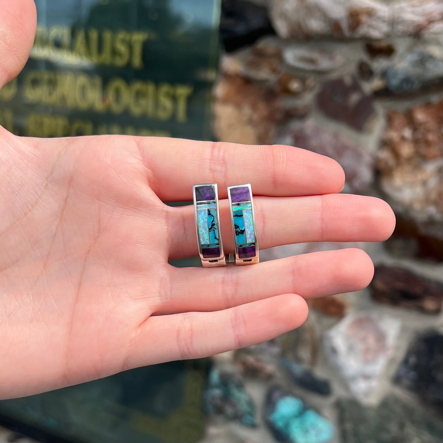 A pair sterling silver inlay earrings set with turquoise, sugilite, and lab created opal stones.