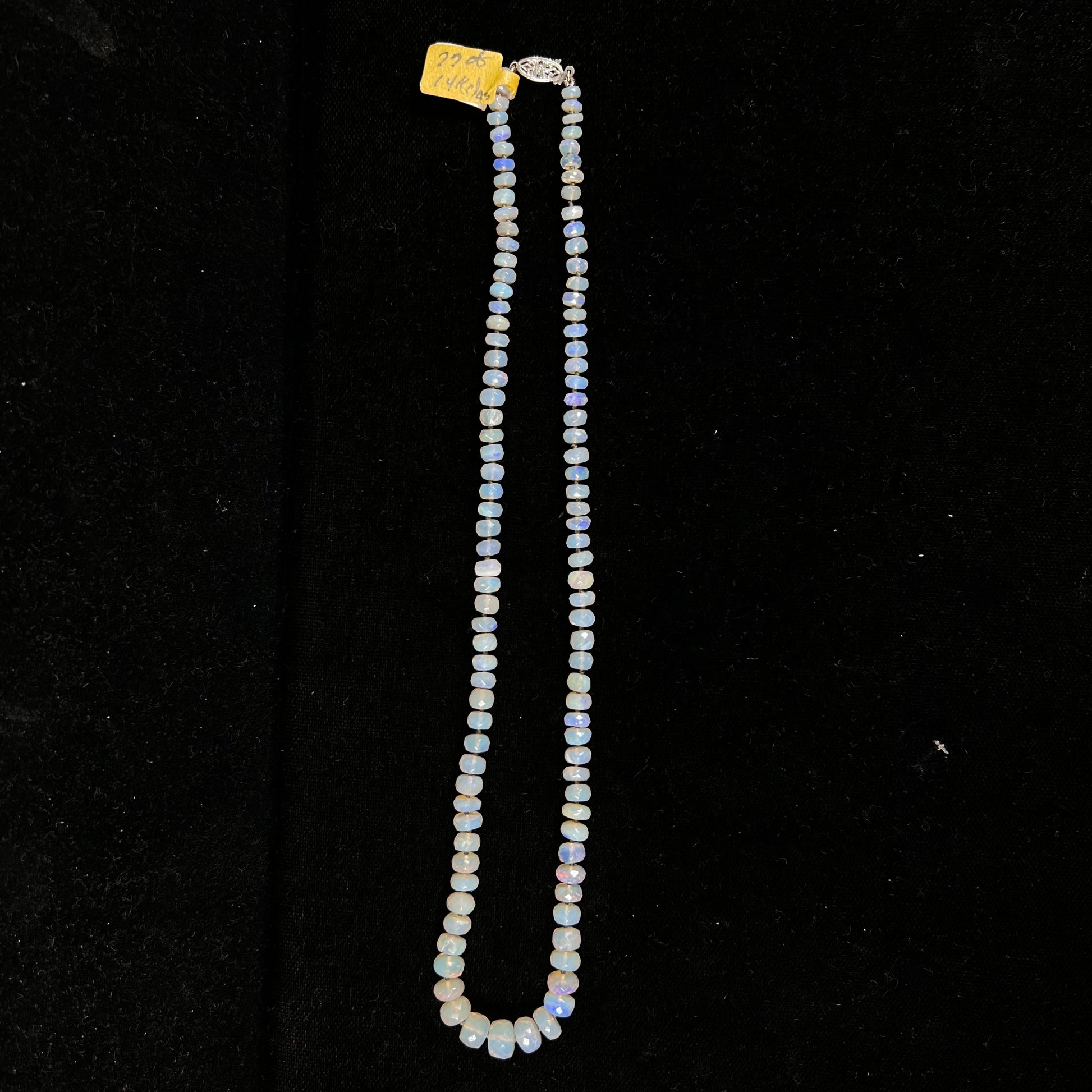 A necklace strand of faceted white crystal opal beads with a white gold clasp.