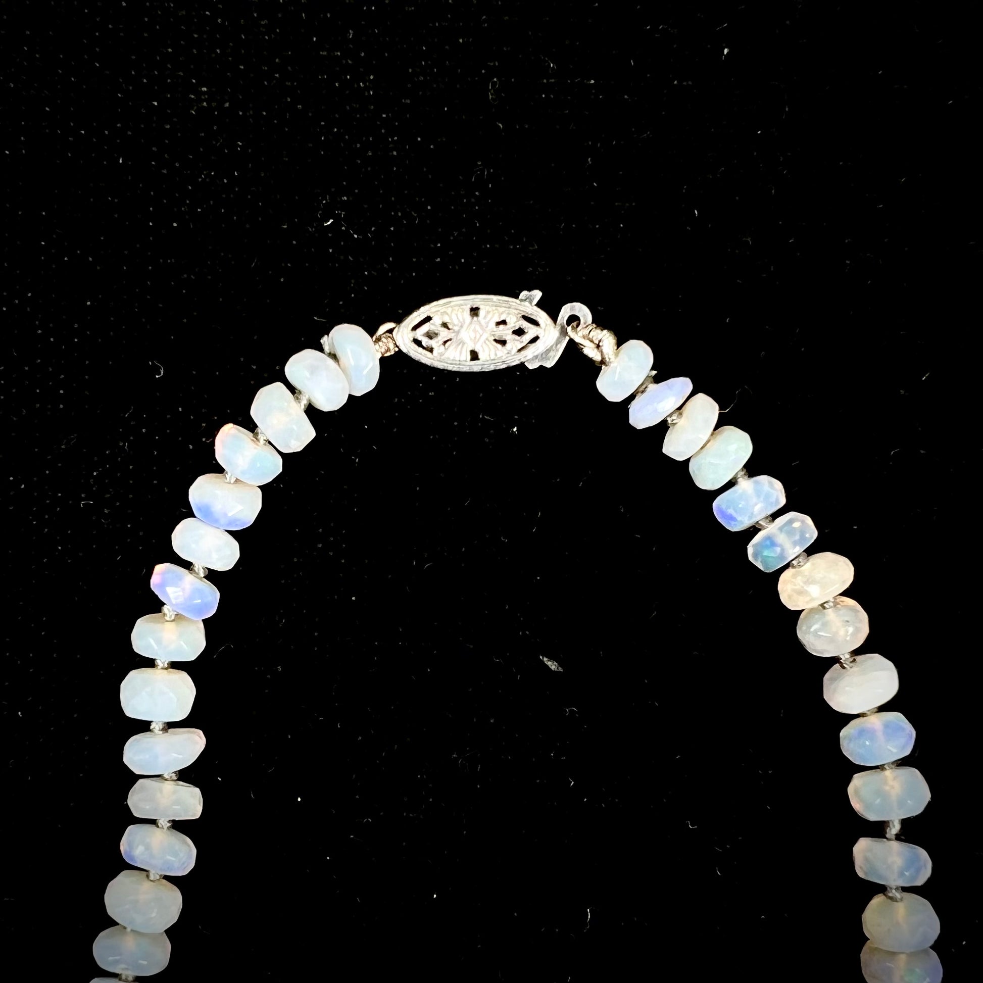 A necklace strand of faceted white crystal opal beads with a white gold clasp.