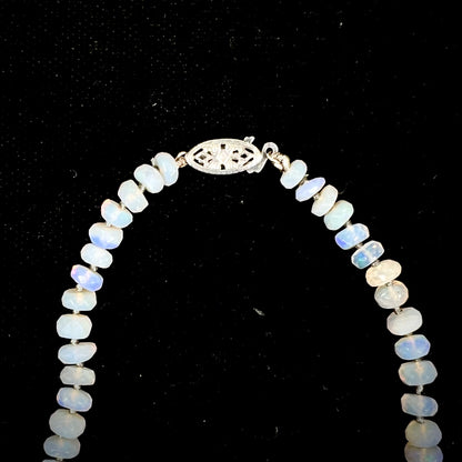 A necklace strand of faceted white crystal opal beads with a white gold clasp.