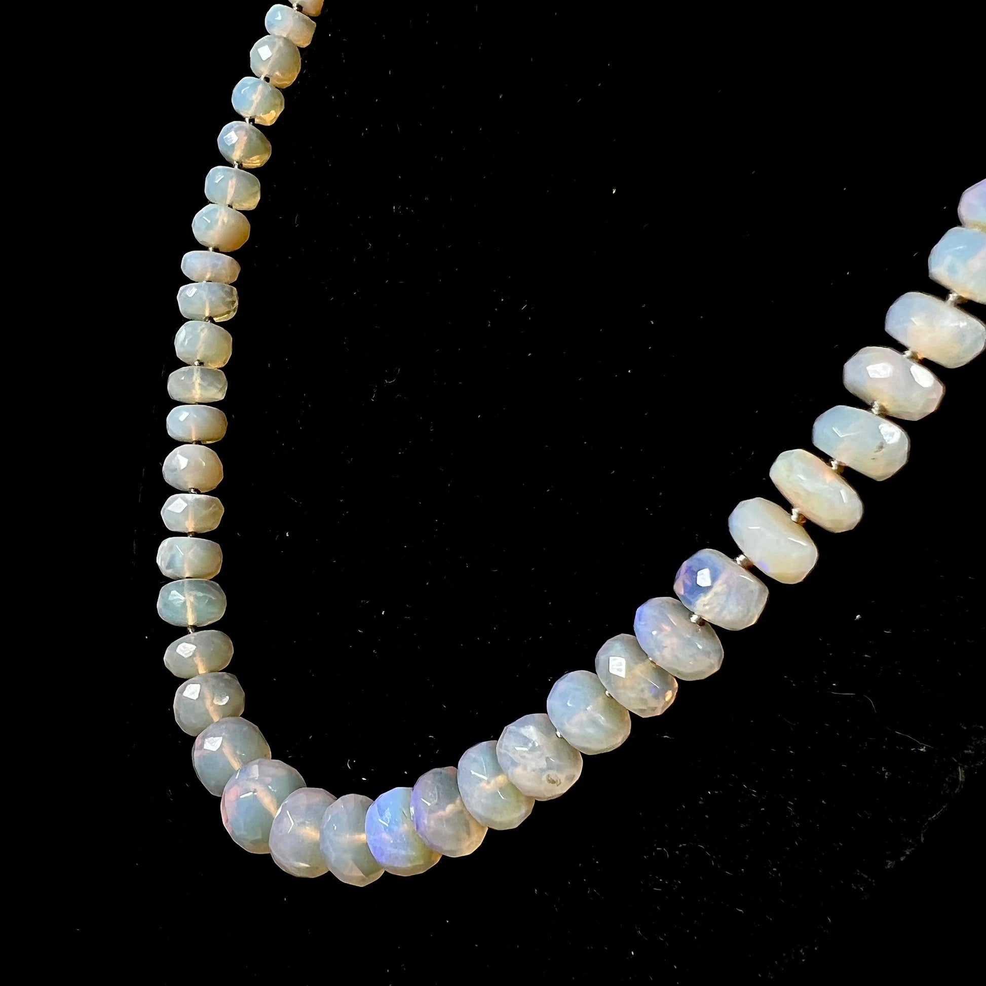 A necklace strand of faceted white crystal opal beads with a white gold clasp.