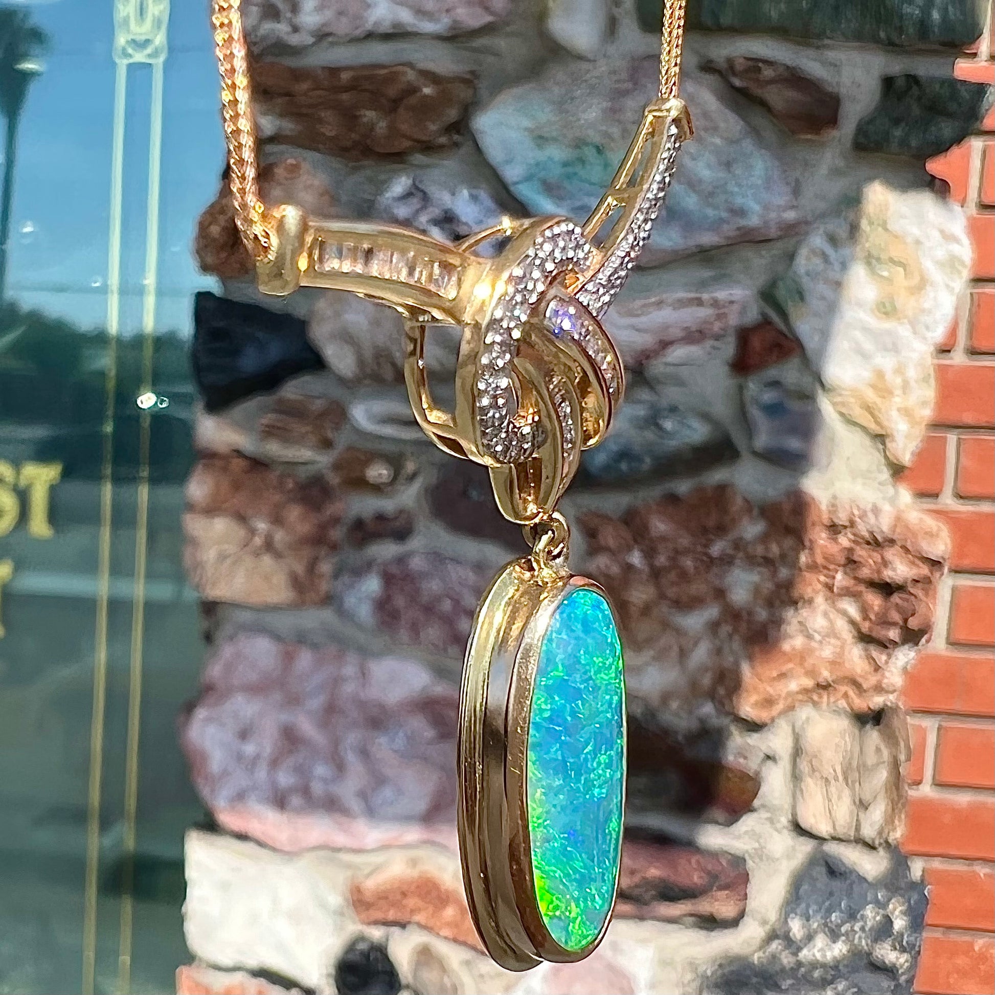A gold black opal and diamond necklace.  There are round, princess cut, and baguette cut diamonds.