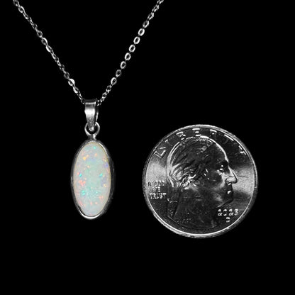 A ladies' adjustable sterling silver necklace bezel set with a natural, oval cabochon cut white crystal opal.
