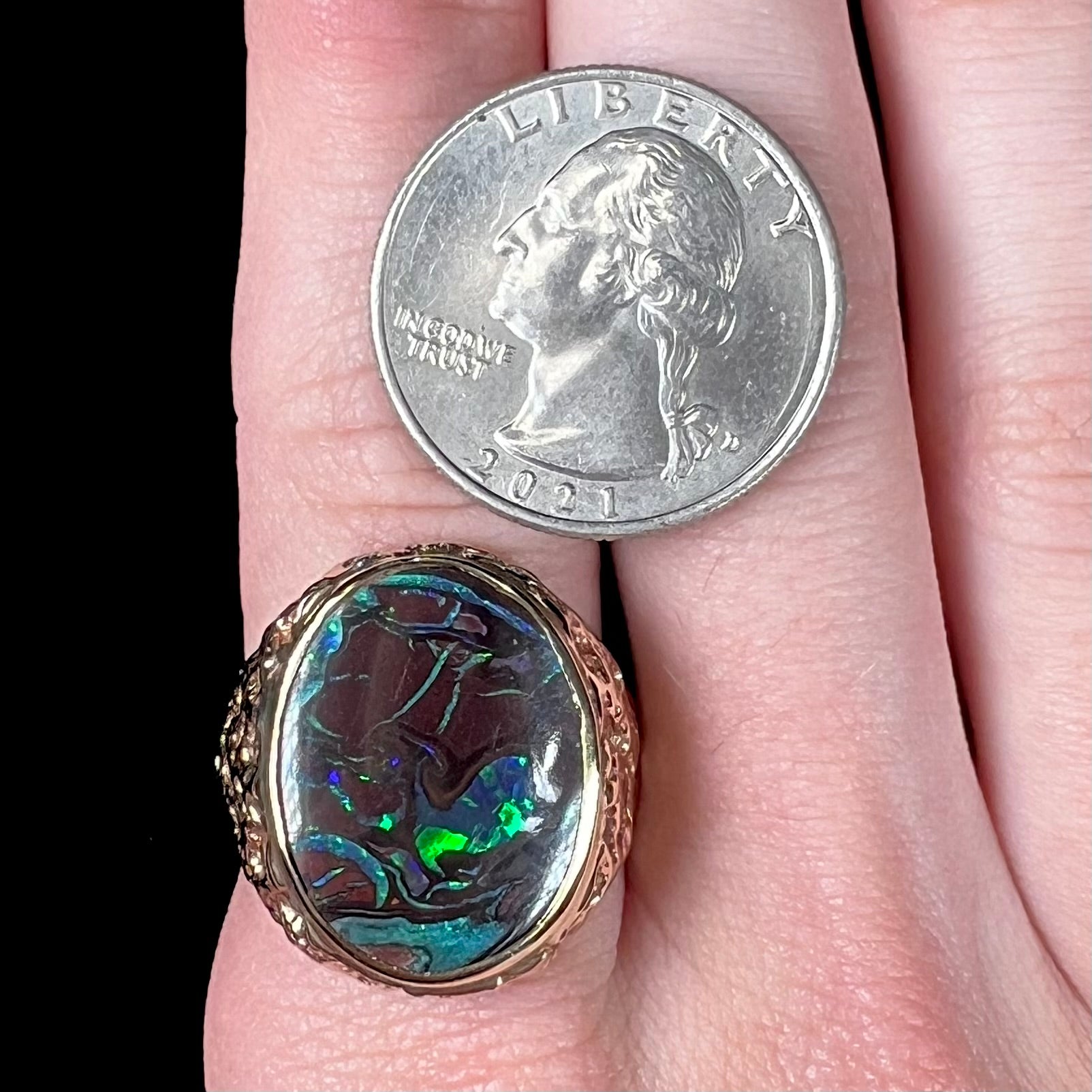 A men's yellow gold nugget style Koroit boulder opal solitaire ring.