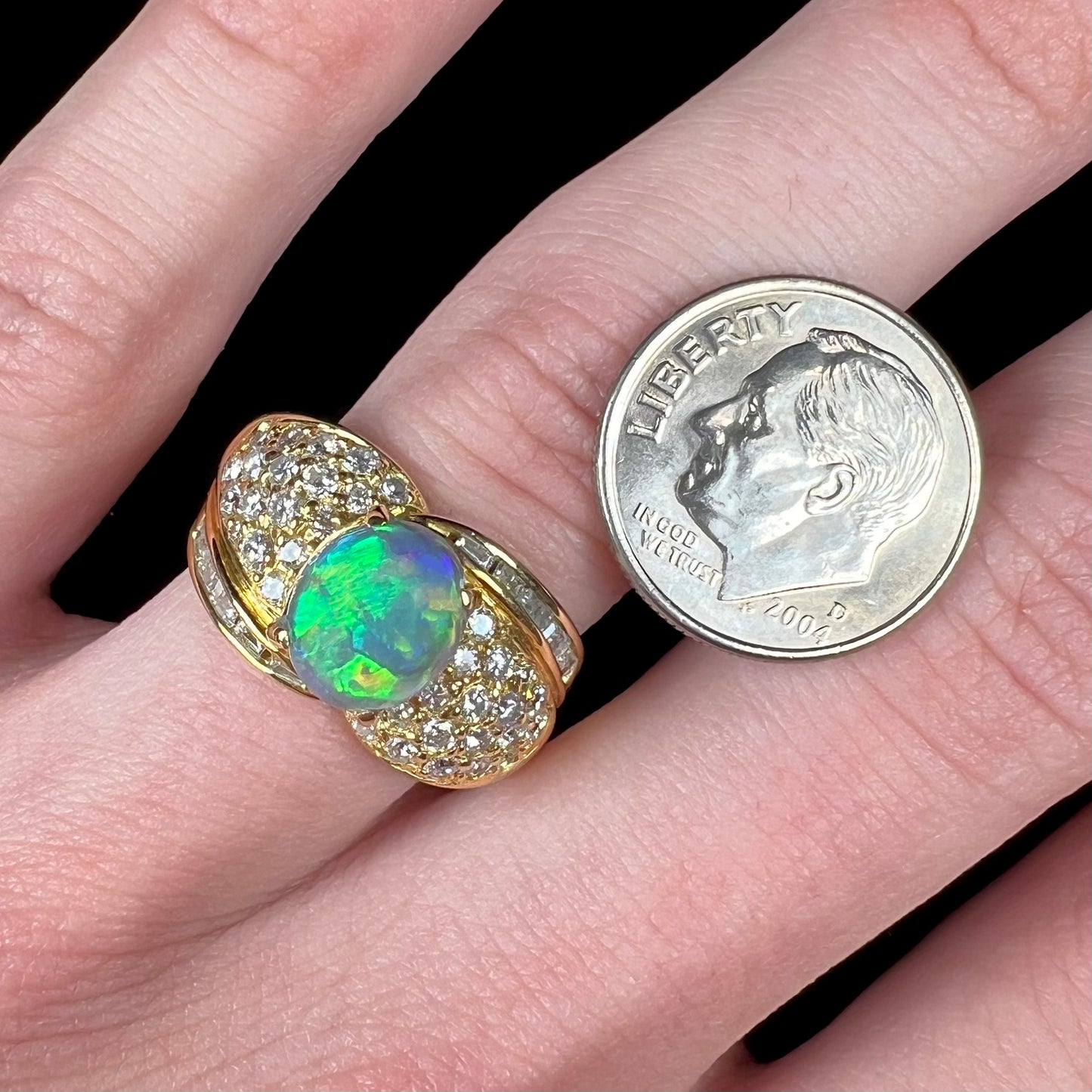 A natural, Australian black opal and diamond ring cast in 18 karat yellow gold..