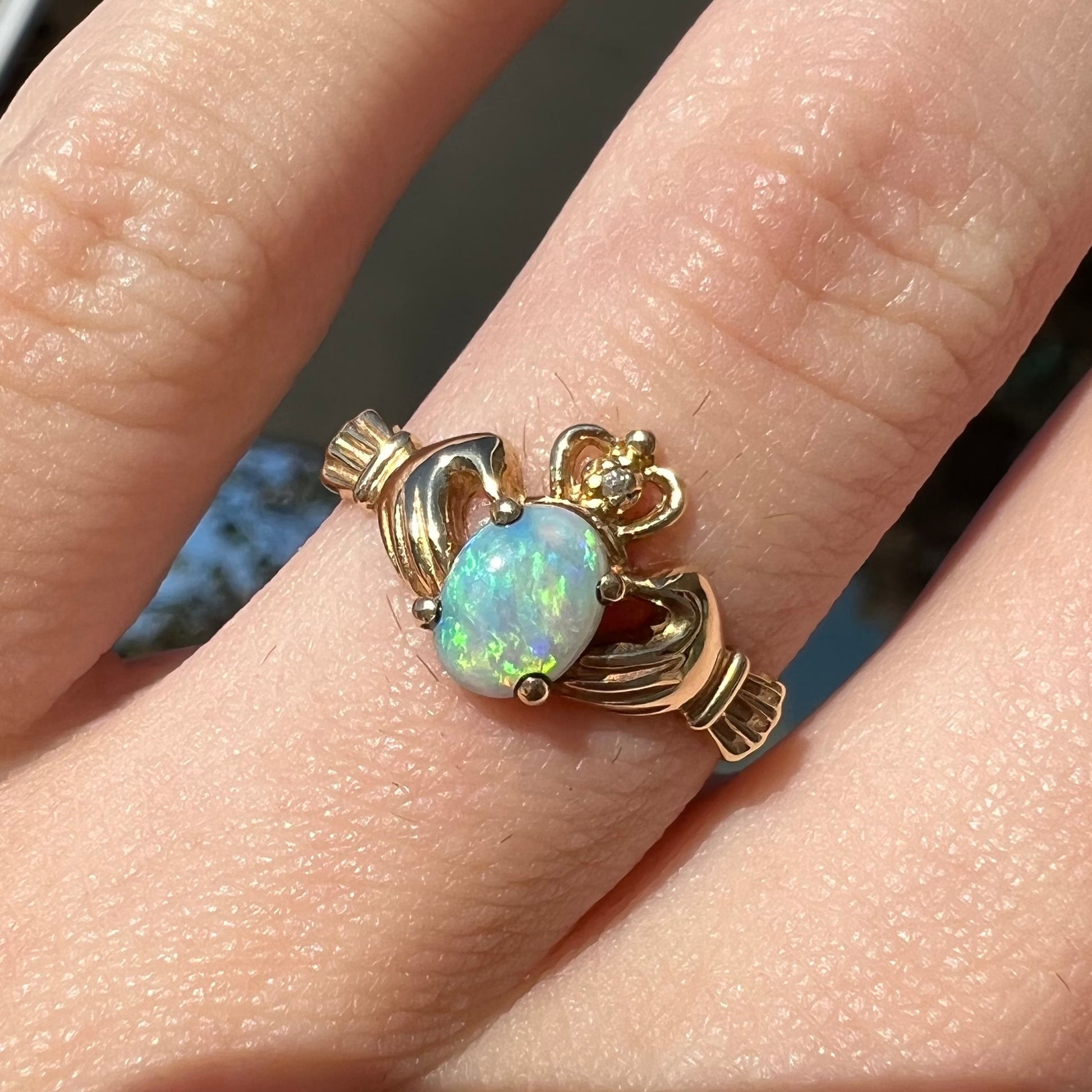 A vintage ladies' yellow gold opal and diamond claddagh ring.