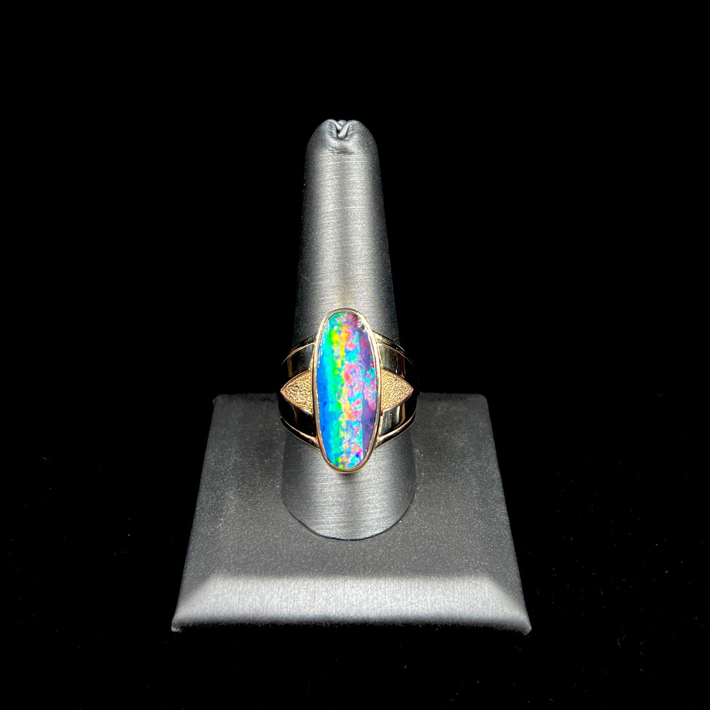 A men's two-tone gold solitaire ring set with a natural boulder opal from Koroit Mining District, Australia.