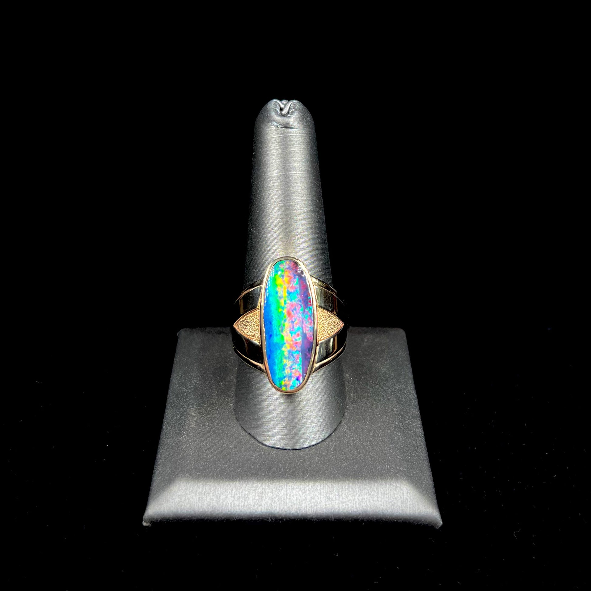 A men's two-tone gold solitaire ring set with a natural boulder opal from Koroit Mining District, Australia.