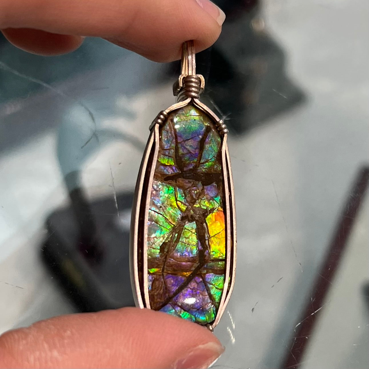 A sterling silver wire wrapped ammolite (gem quality rainbow ammonite) necklace.