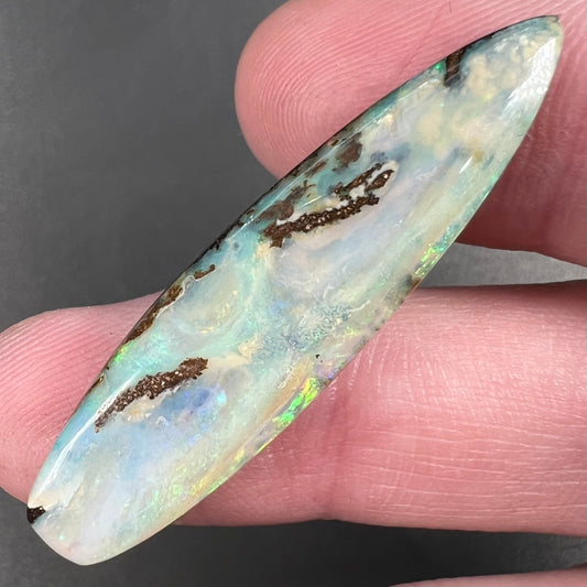 A loose, polished, point shape Quilpie boulder opal stone from Queensland, Australia.