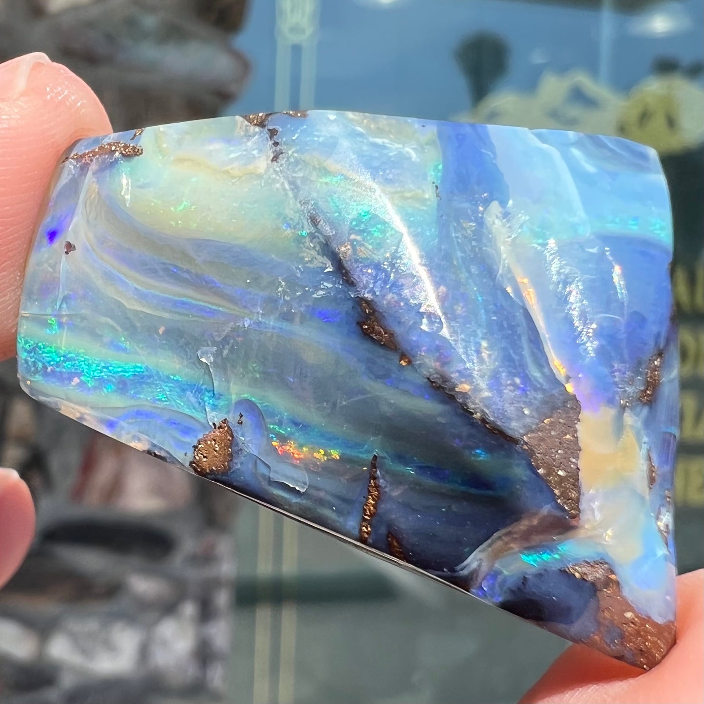 A loose, polished blue boulder opal specimen from Queensland, Australia.