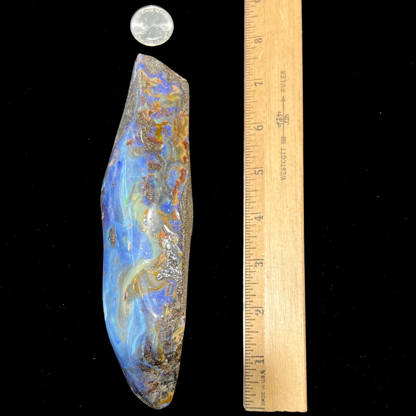 A 7 inch long polished blue Quilpie boulder opal specimen from Queensland, Australia.