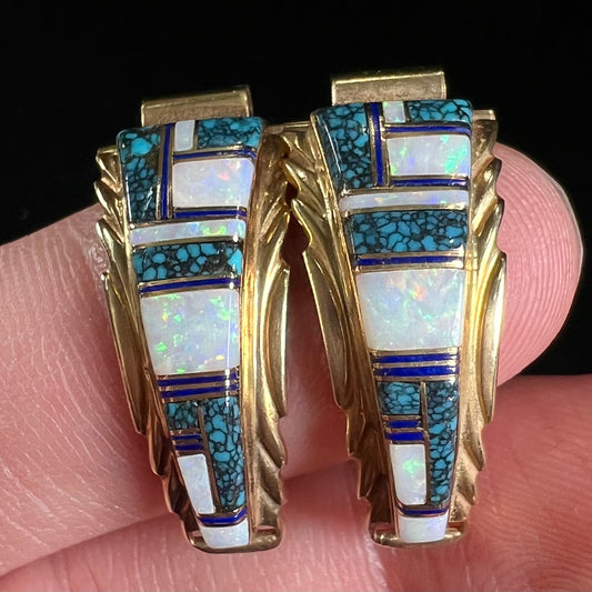 A pair of ladies' yellow gold watch cuffs inlaid with spiderweb turquoise and white crystal opal.