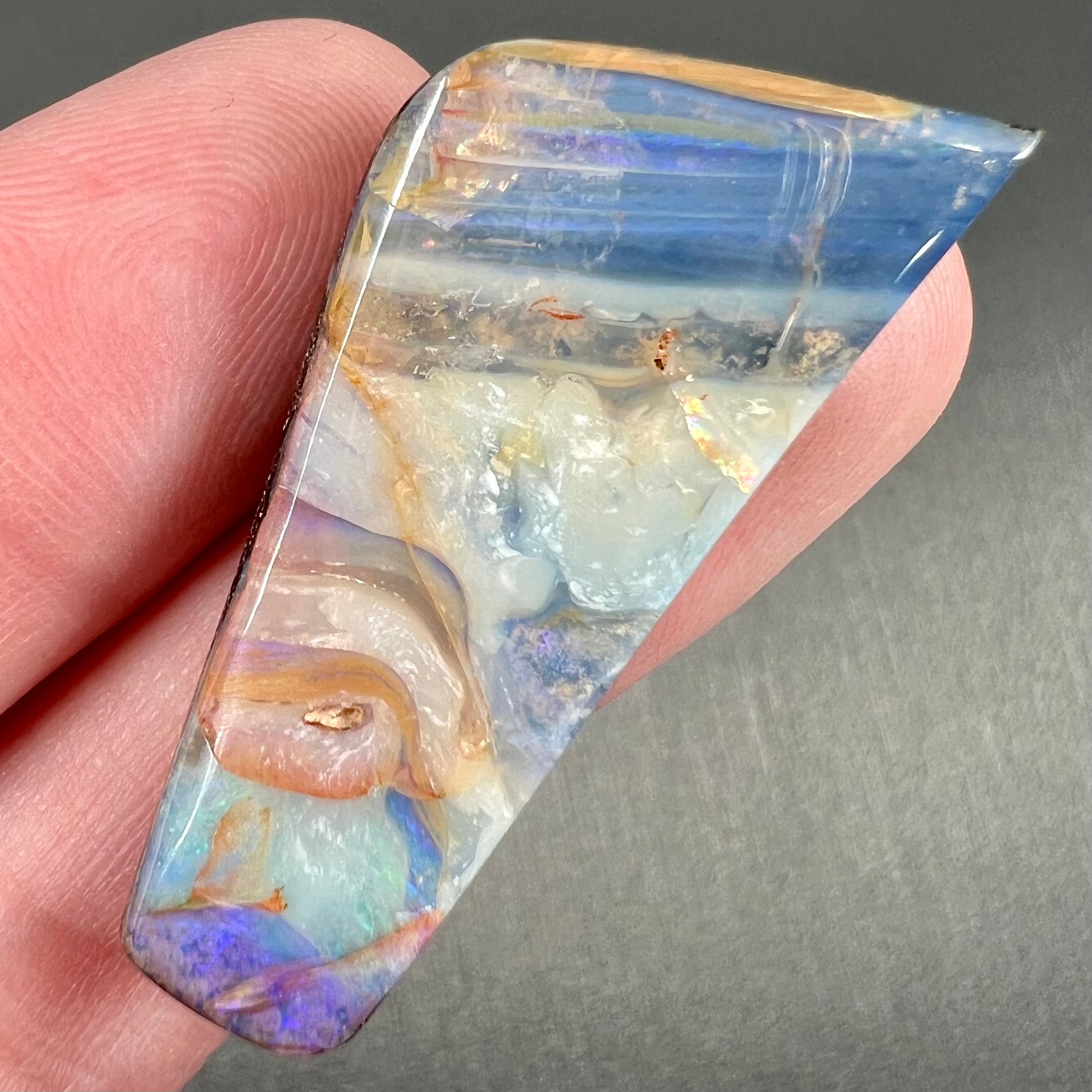A loose, freeform cut, patterned Quilpie boulder opal stone from Queensland, Australia.