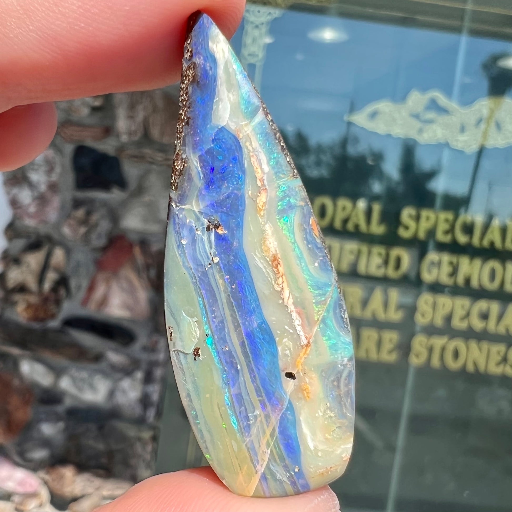 A loose, pear shaped boulder opal stone from Queensland, Australia.