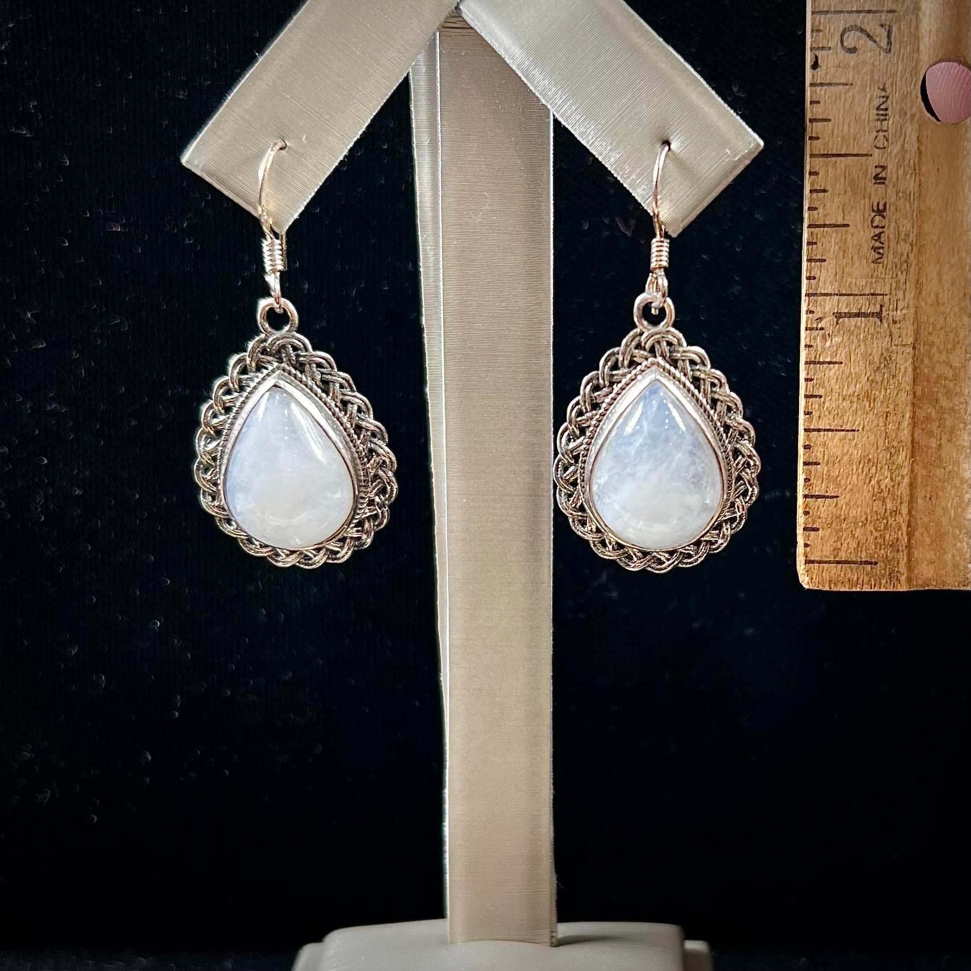 Silver filigree dangle wire earrings set with pear shape moonstones.