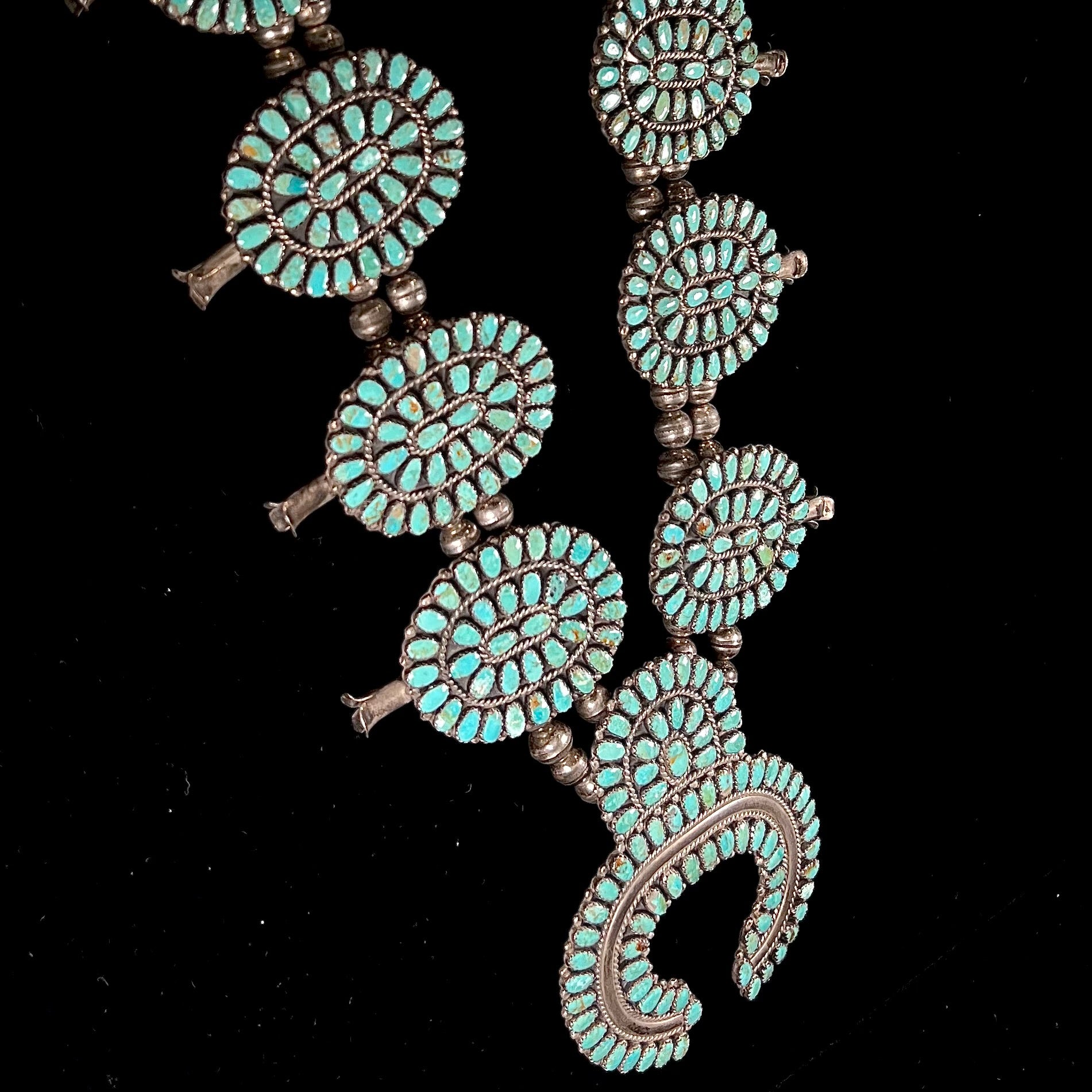 A Native American silver squash blossom turquoise petit point set with turquoise by Larry Moses Begay.