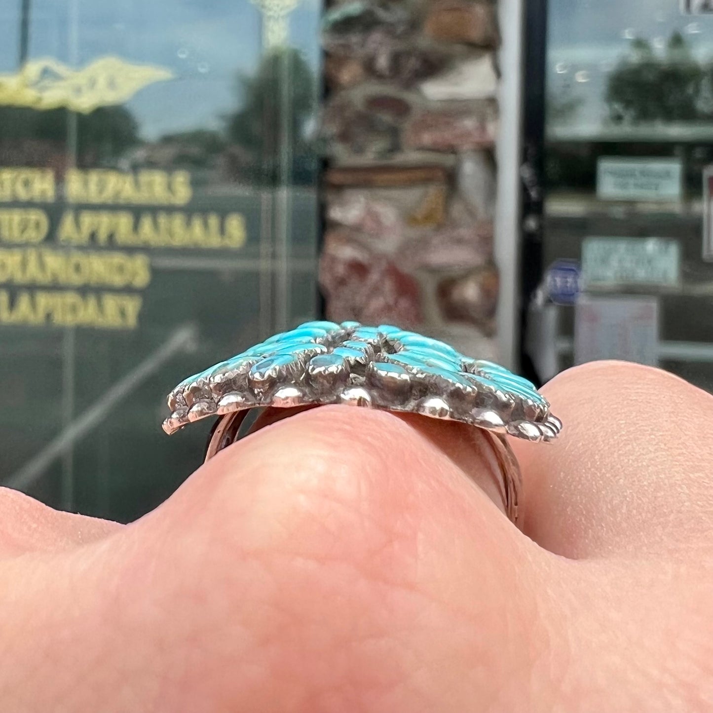 A petit point silver Zuni turquoise ring handmade by New Mexico artist Milburn Dishta.