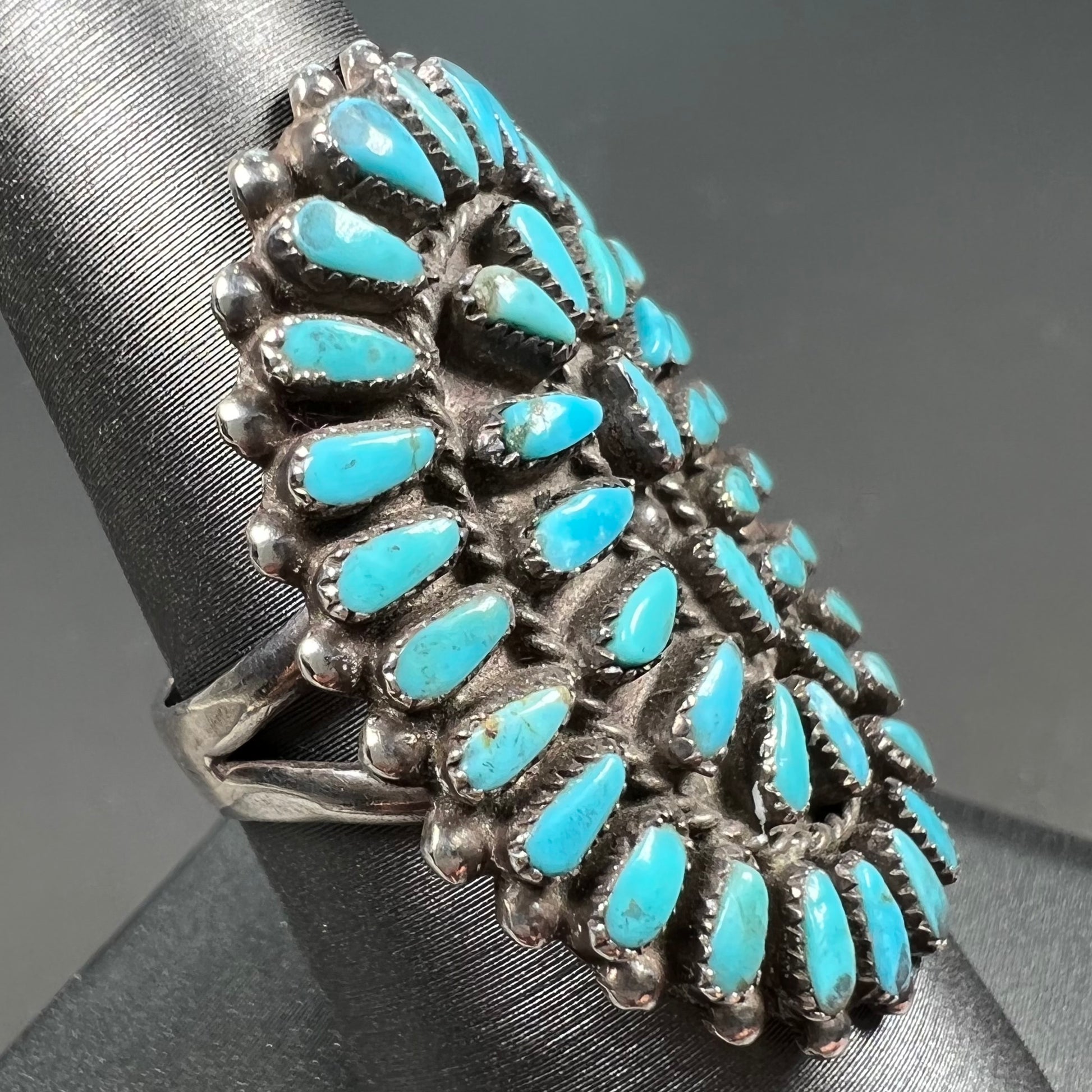 A petit point silver Zuni turquoise ring handmade by New Mexico artist Milburn Dishta.