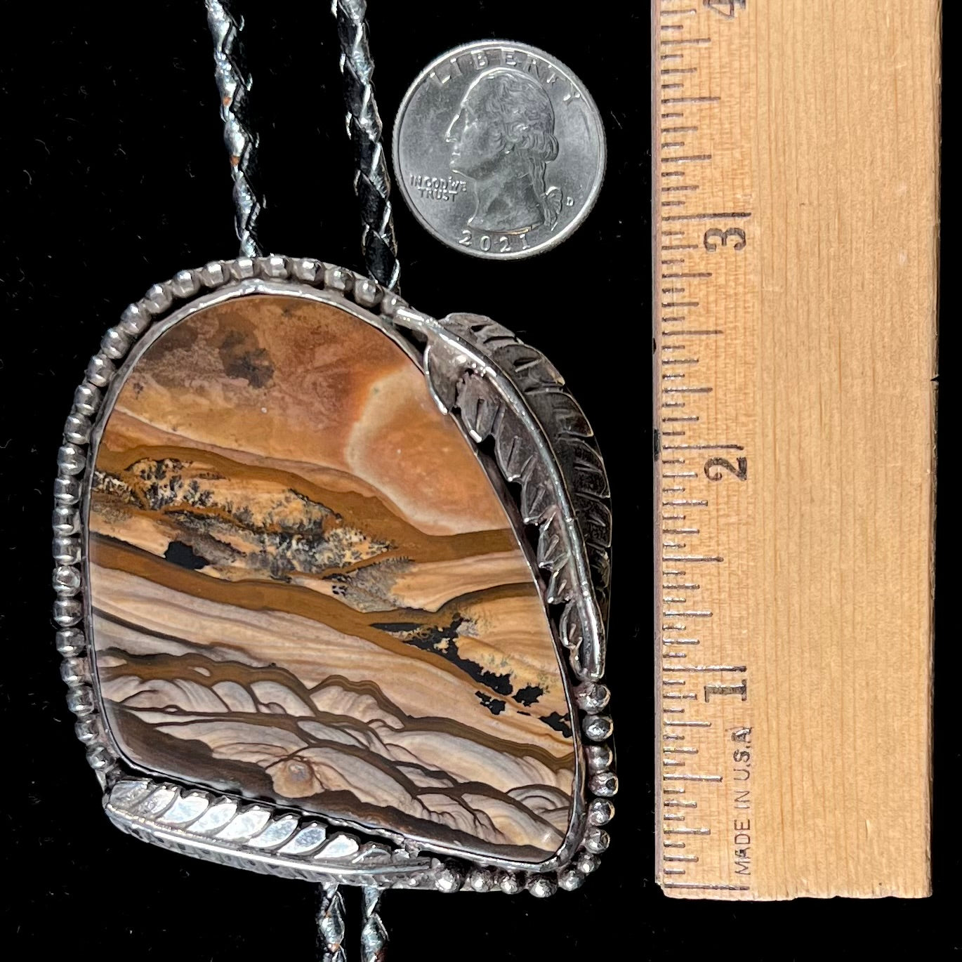 A men's sterling silver bolo tie set with a Biggs picture jasper stone.
