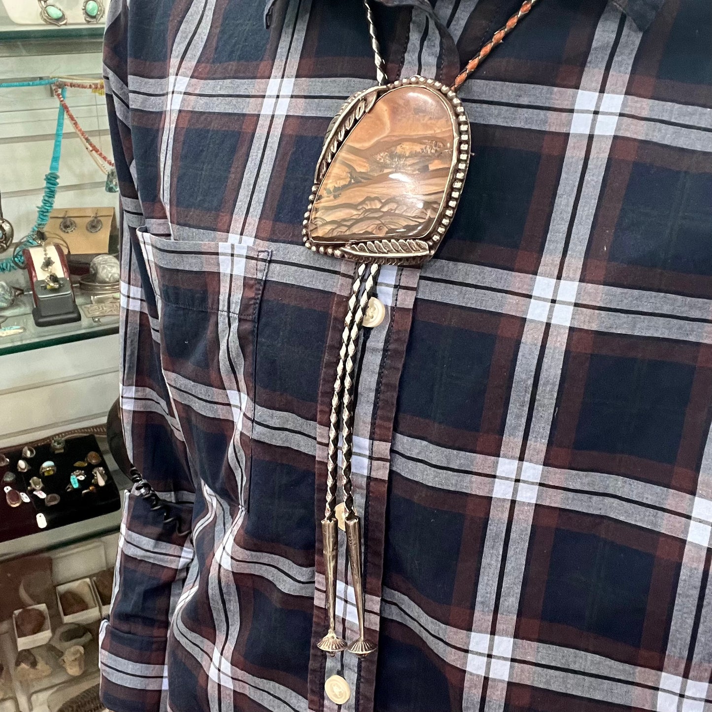 A men's sterling silver bolo tie set with a Biggs picture jasper stone.