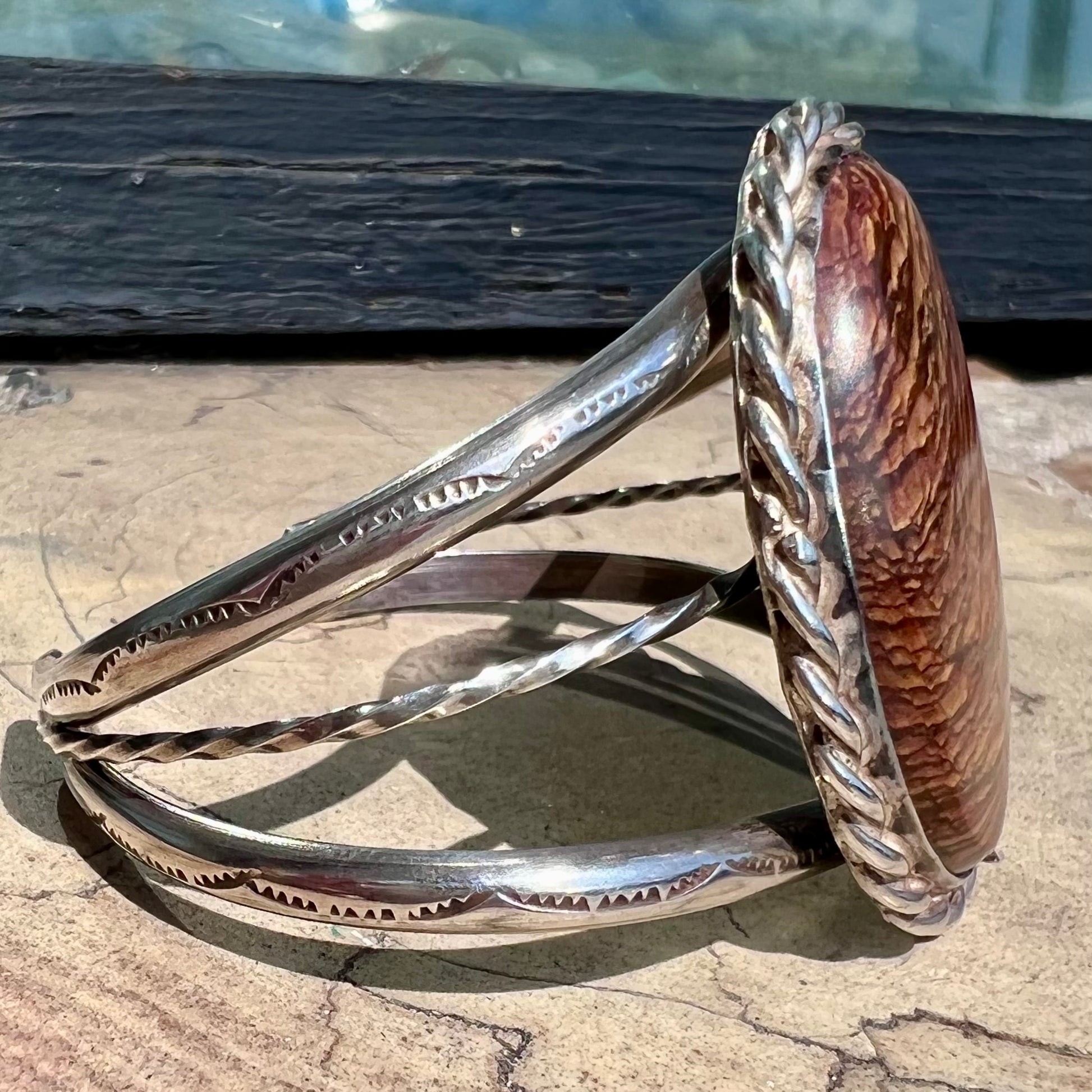 A sterling silver rope bezel set picture jasper cuff bracelet.