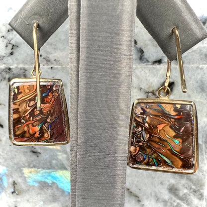 A pair of yellow gold French wire dangle earrings set with Koroit boulder opal.