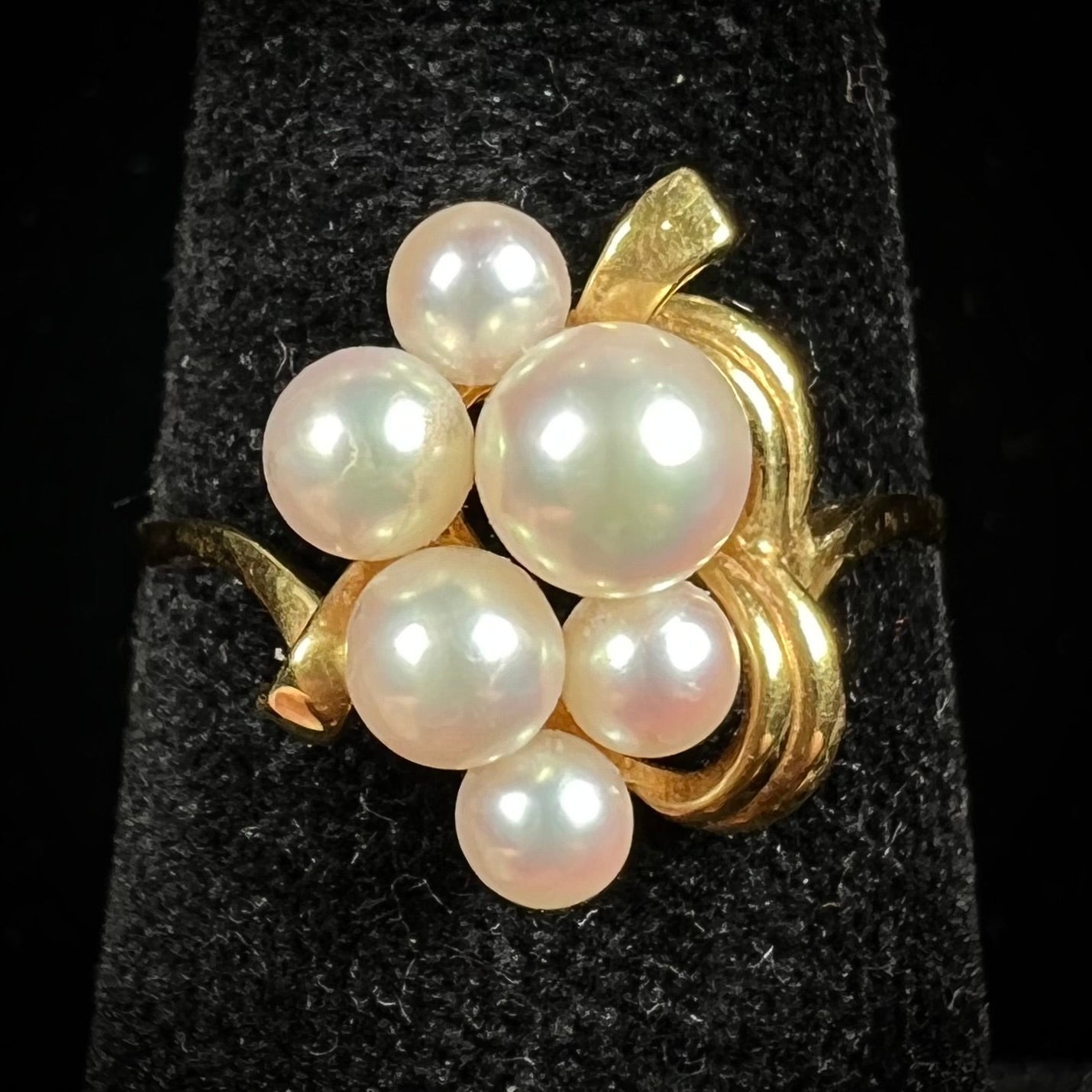 A yellow gold Akoya pearl cluster ring.  The pearls are round with pink overtones and resemble bubbles.