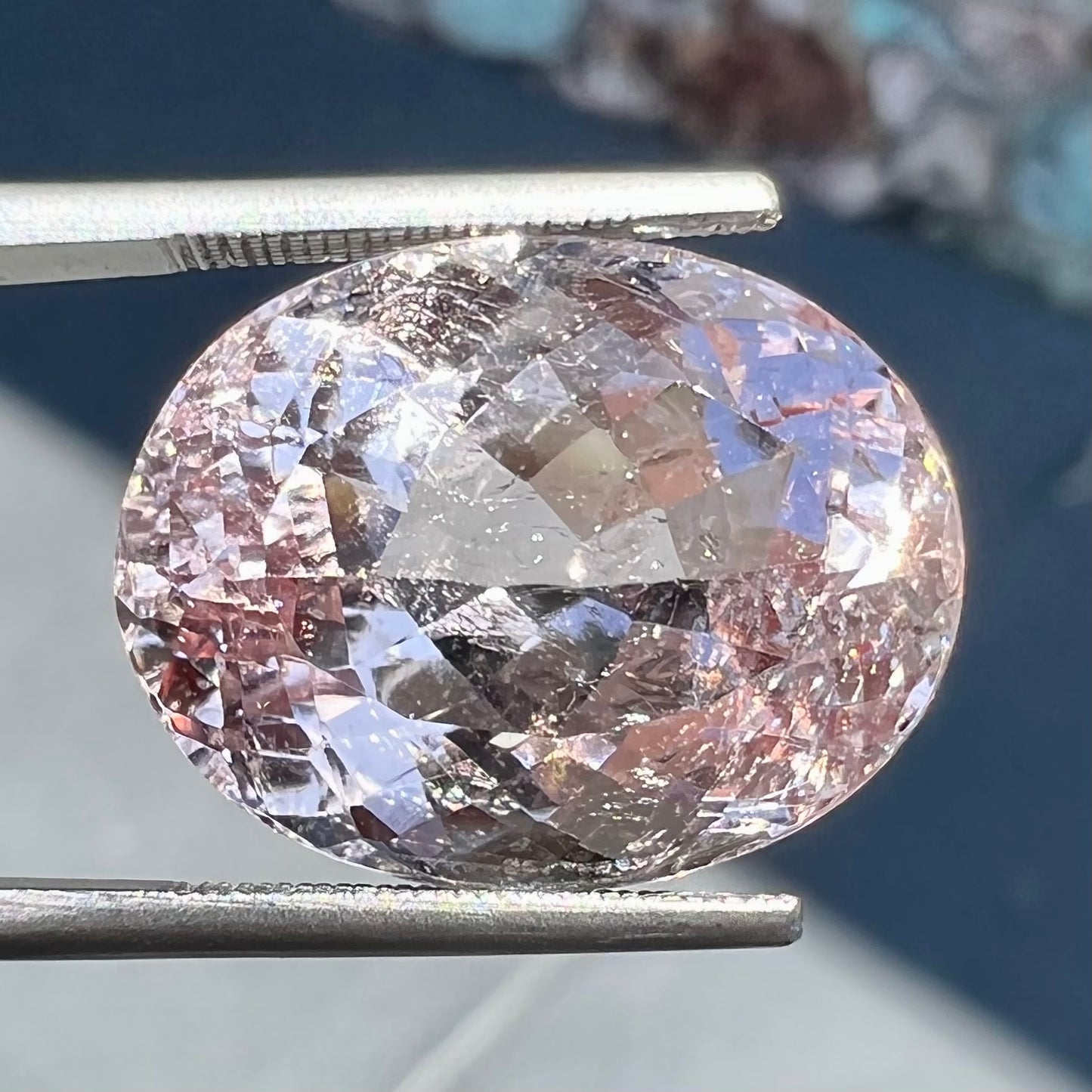 A loose, faceted oval cut pink morganite stone weighing over 14 carats.