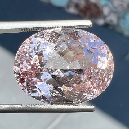 A loose, faceted oval cut pink morganite stone weighing over 14 carats.