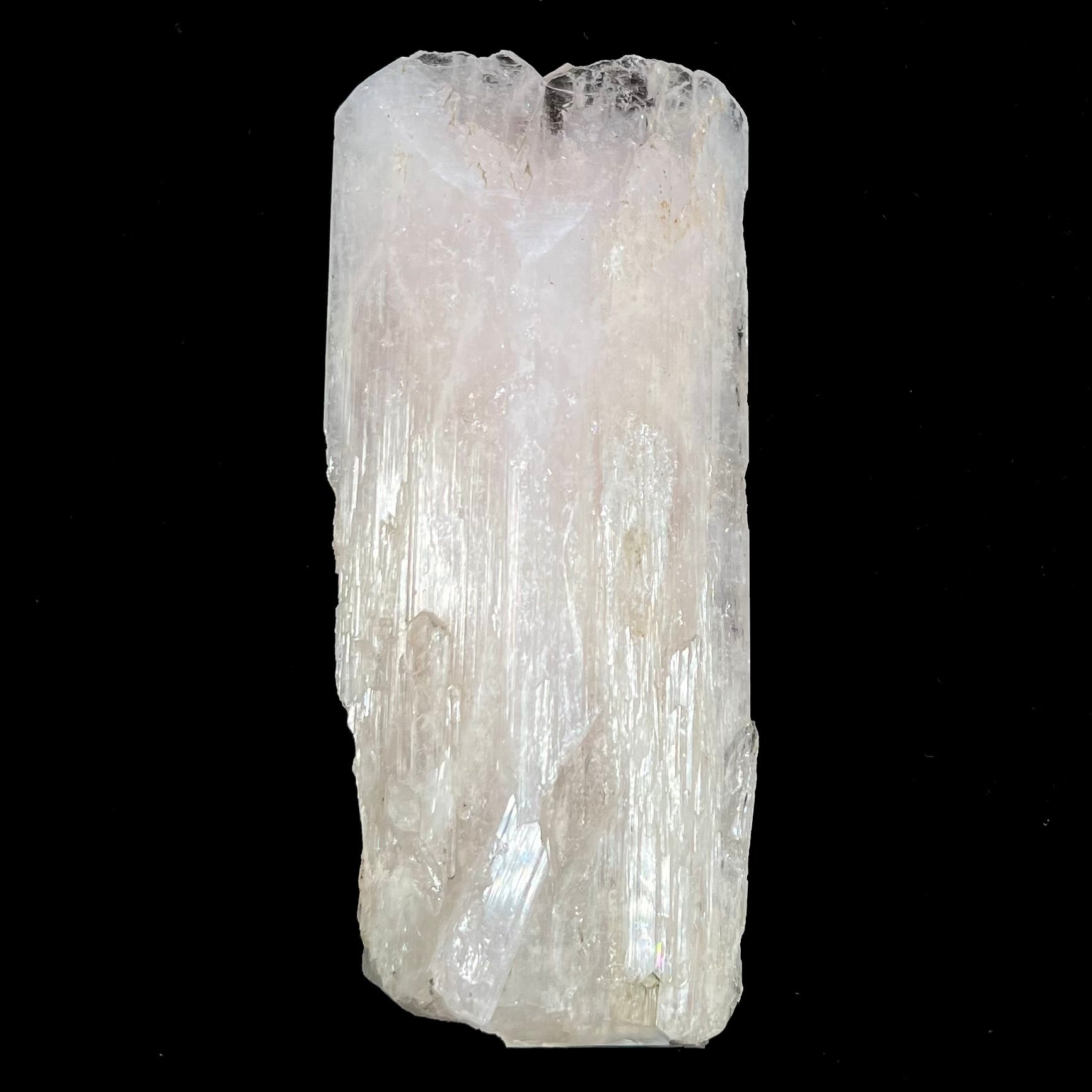 A 5.5 inch long pink danburite crystal that weighs over one pound.
