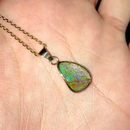 Natural green and salmon pink Australian boulder opal set in a 14 karat yellow gold bezel pendant on a gold plated sterling silver cable link chain. 