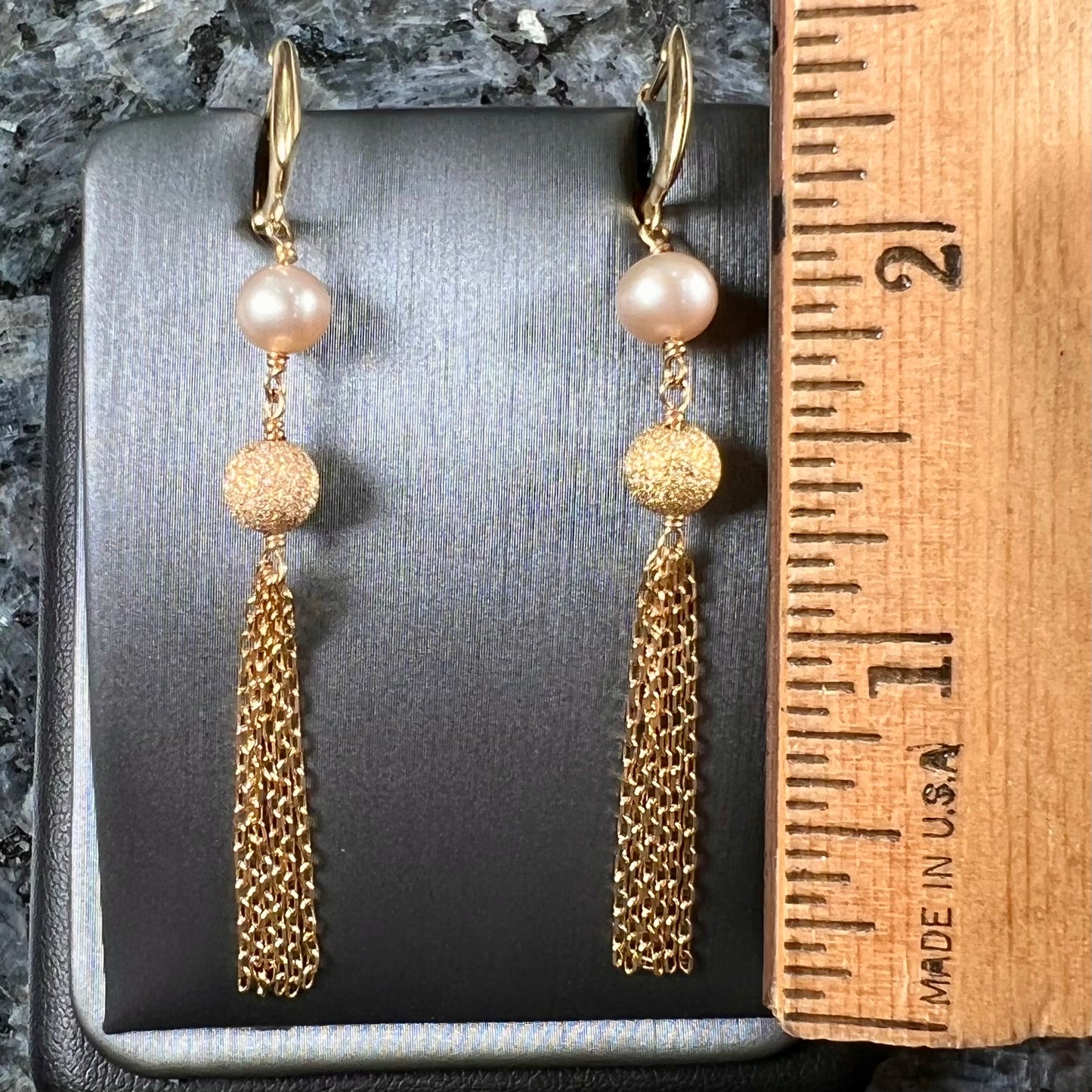 A pair of yellow gold and pink pearl dangle earrings.