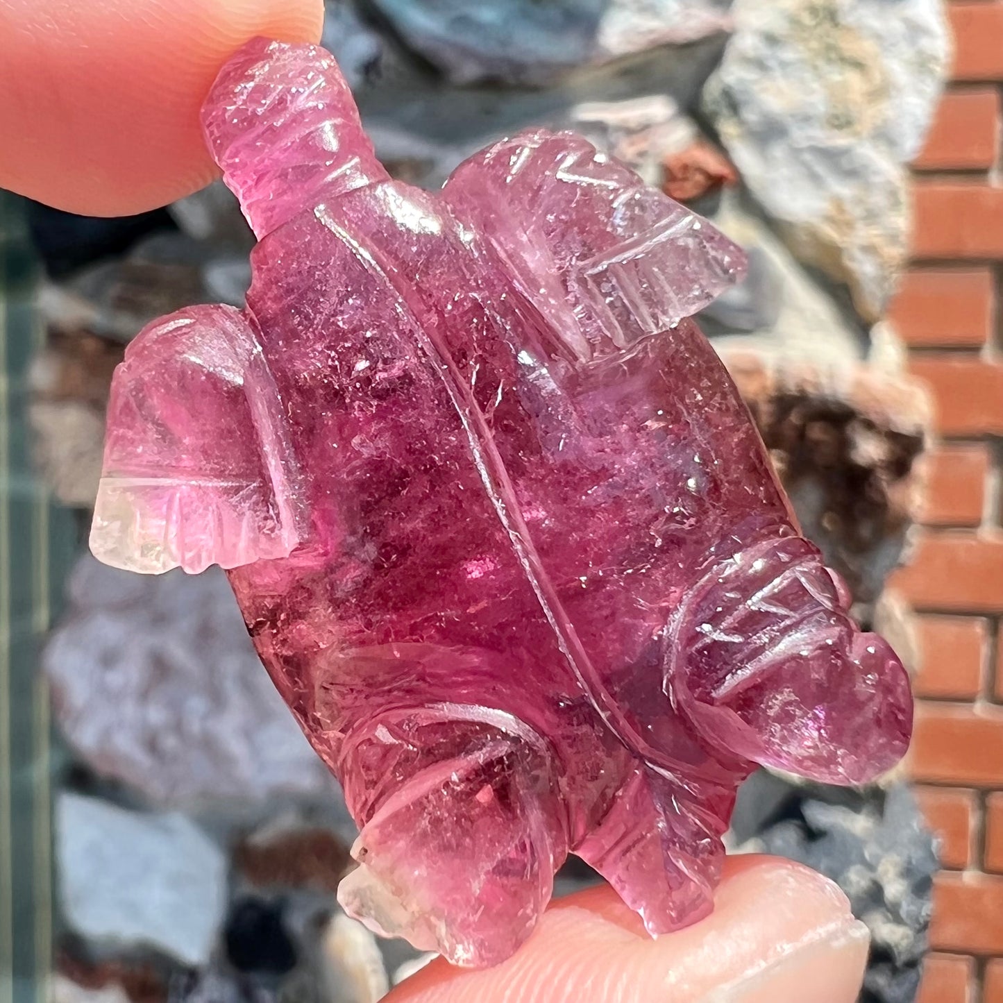 A crystal turtle carved from a pink tourmaline stone.