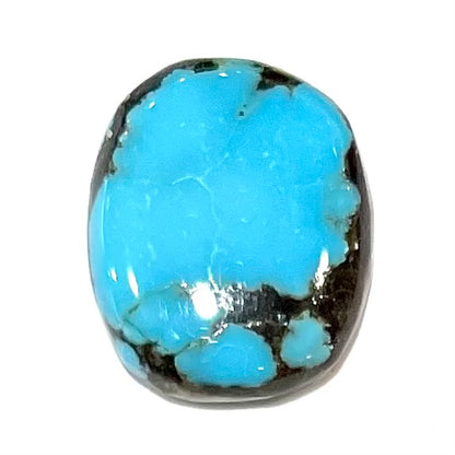 A loose turquoise stone from Pinto Valley Mine, Arizona.  The piece is blue with a black matrix.