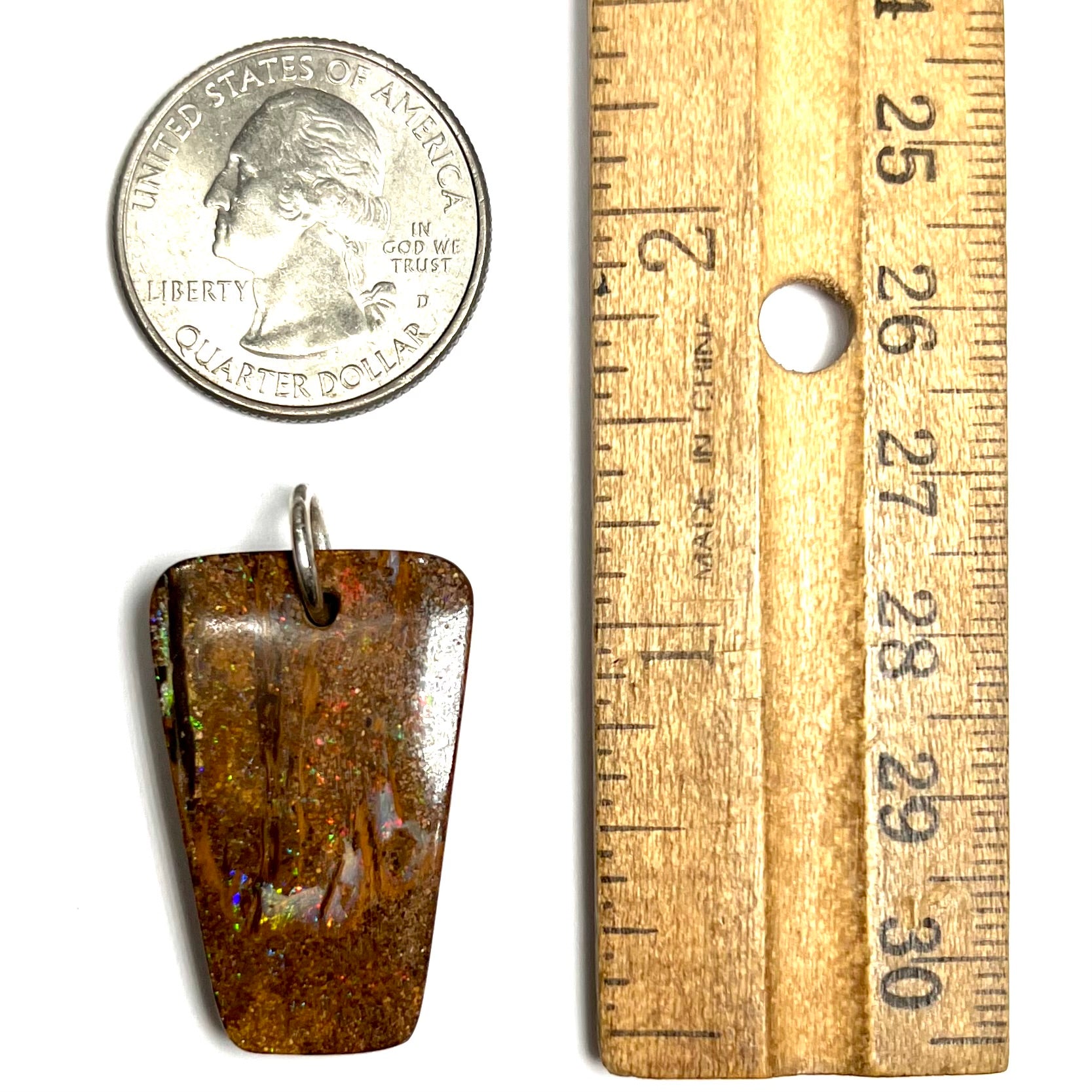 A drilled boulder opal stone with a sterling silver ring through the hole to be worn as a pendant.