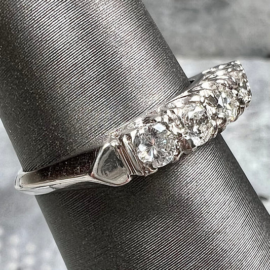 A vintage style ladies' platinum wedding band set with five round diamonds.