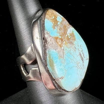 A men's sterling silver ring set with a powder blue turquoise stone.  The ring is rustic style.