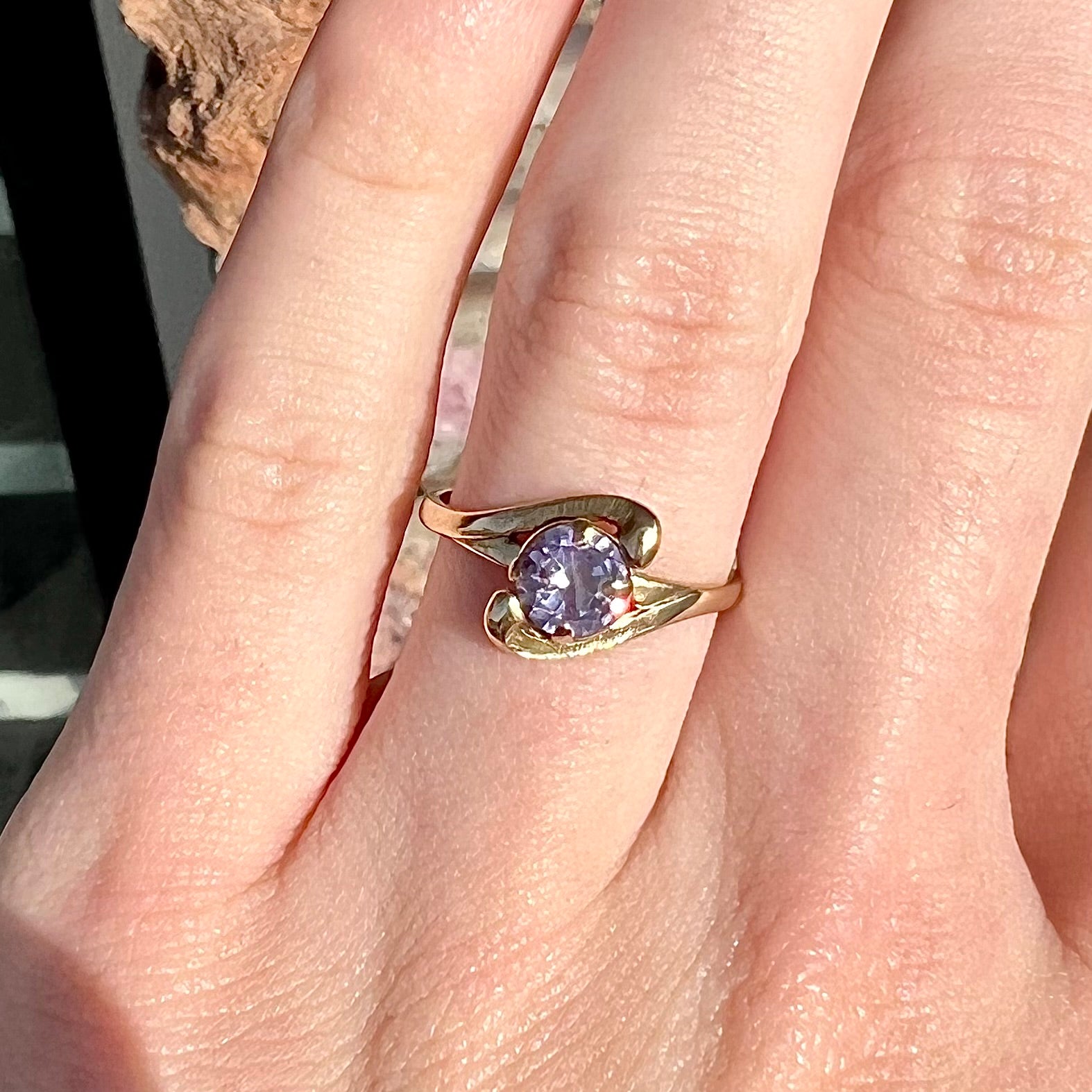 A vintage 1960's yellow gold ring set with a round synthetic purple alexandrite.  The prongs are worn.