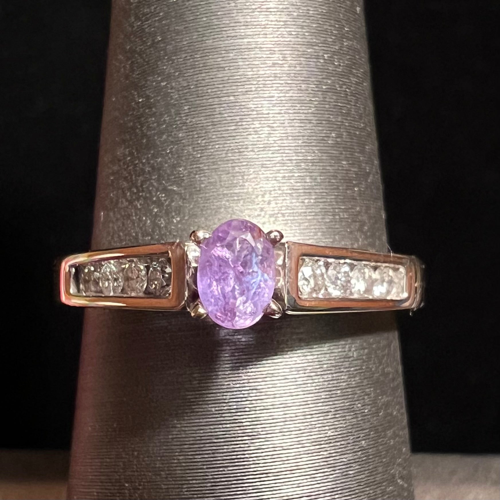 A ladies' white gold and diamond ring set with a 0.26ct alexandrite center stone that changes from green blue to lilac purple.