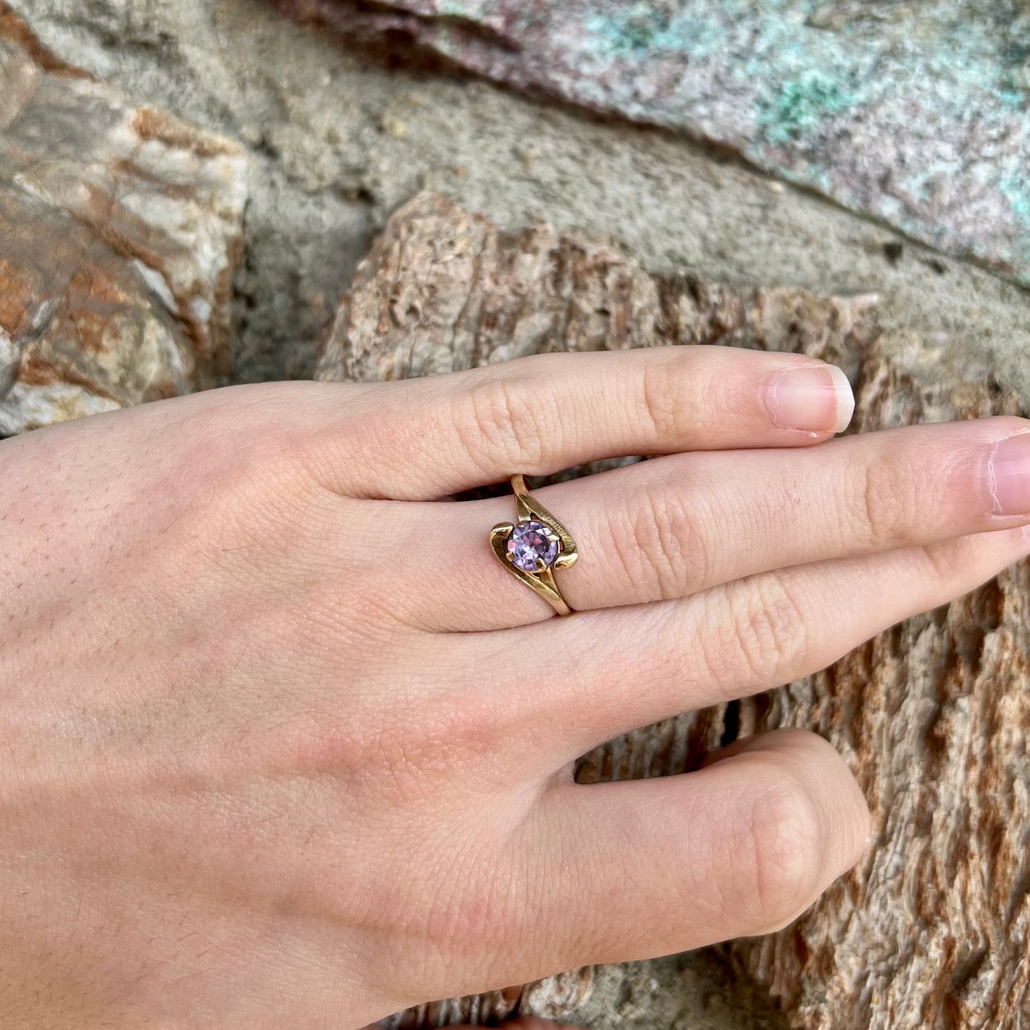 A vintage 1960's yellow gold ring set with a round synthetic purple alexandrite.  The prongs are worn.