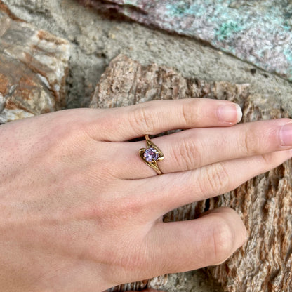 A vintage 1960's yellow gold ring set with a round synthetic purple alexandrite.  The prongs are worn.