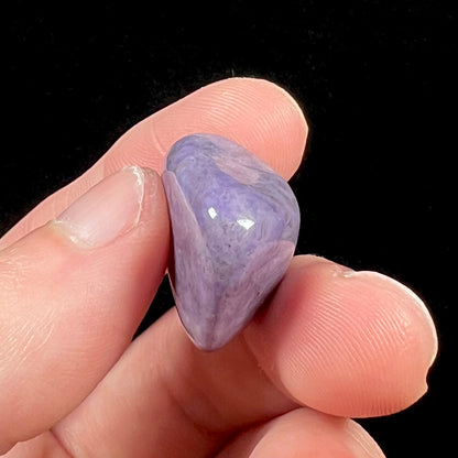 A tumbled Turkish purple jade stone, known as turkiyenite.